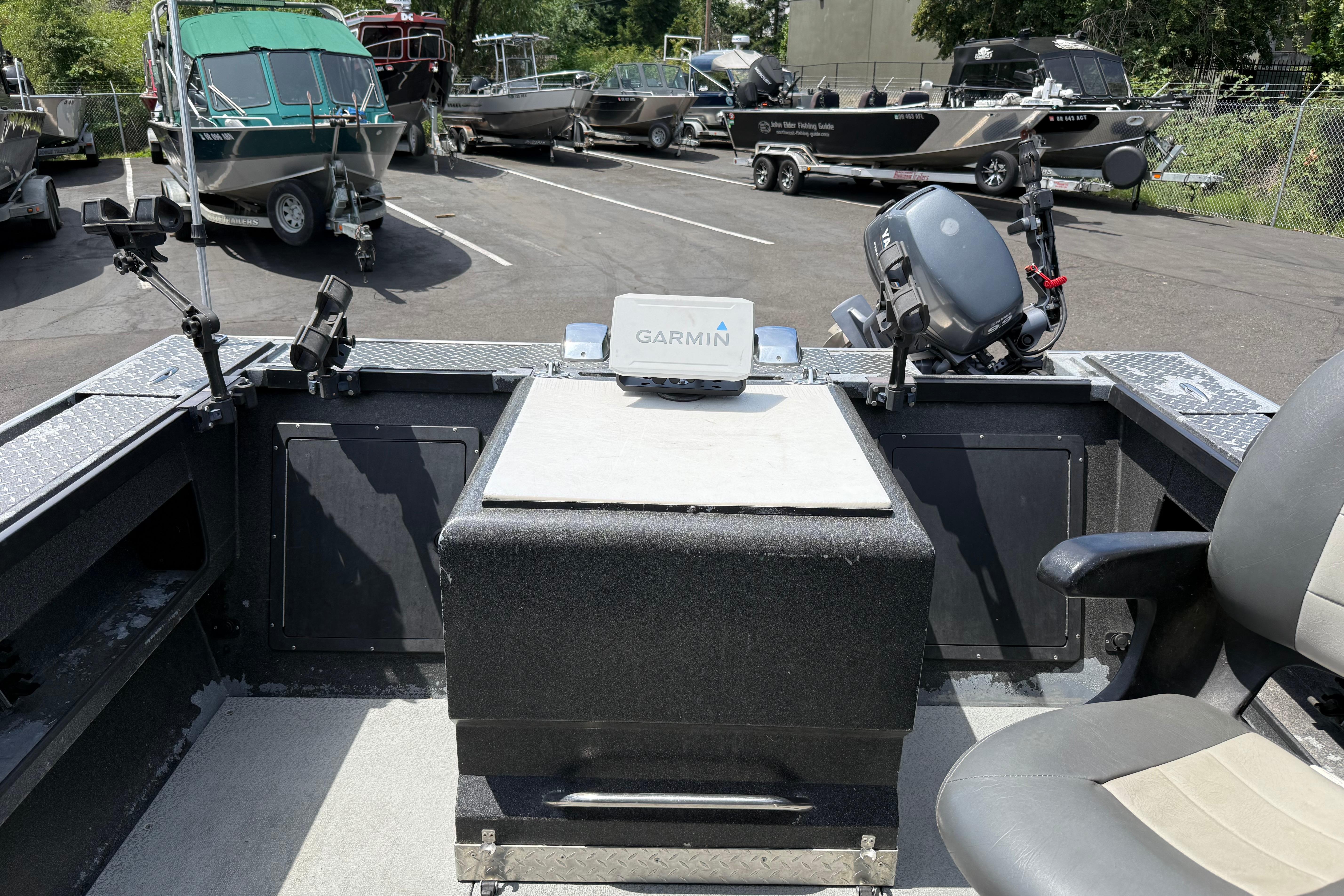 2005 Willie Raptor 21' boat interior with Garmin device, parked among other boats.