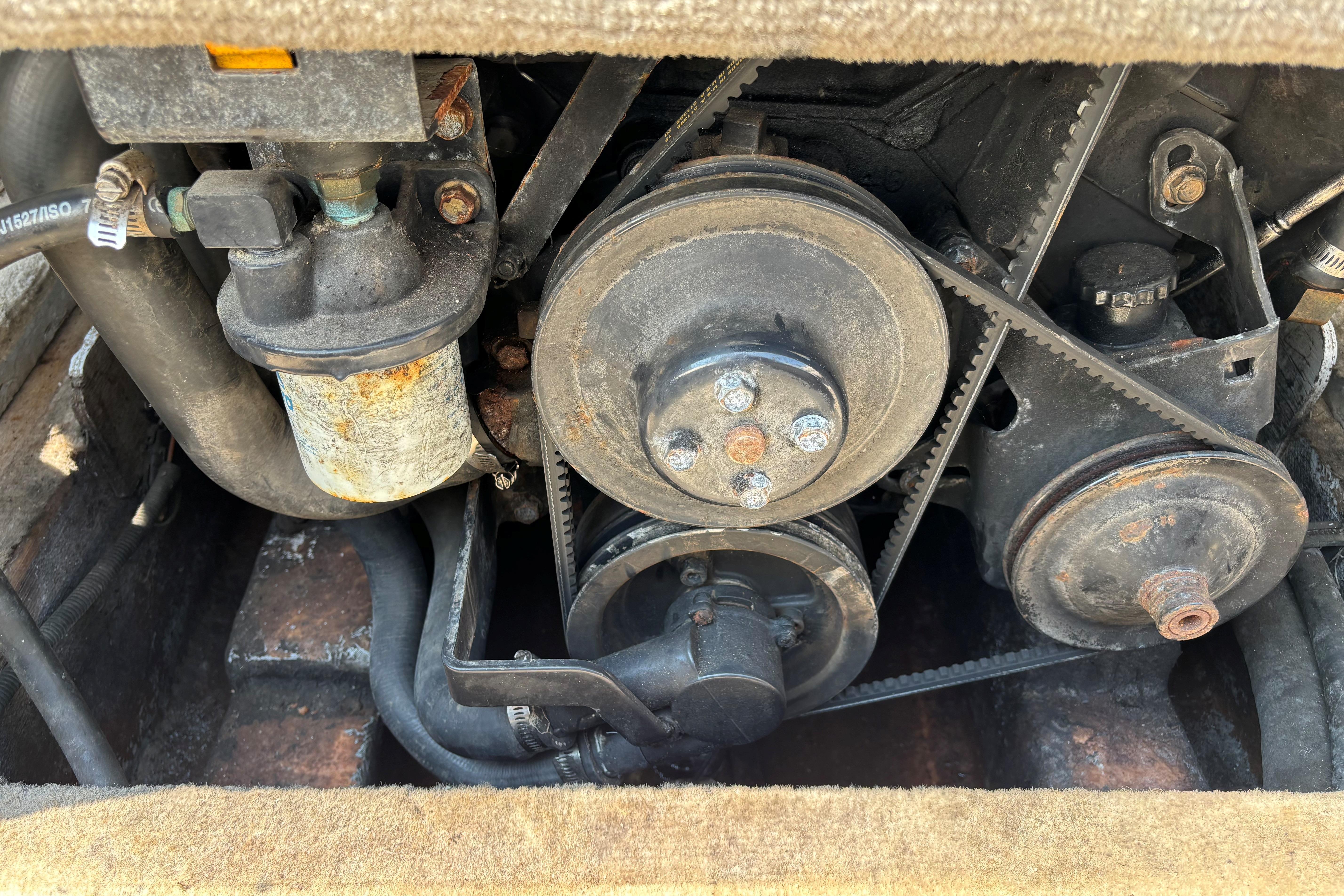 Engine components of a 2001 Crownline 18' boat, featuring belts and pulleys.