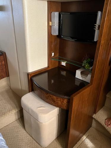 2009 Ovation 52 yacht interior with TV and vanity desk.