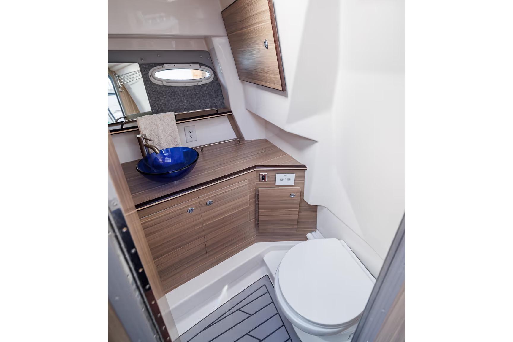 Manufacturer Provided Image: Modern bathroom in 2026 Solara S-310 SB boat with sleek wood cabinetry and blue vessel sink.