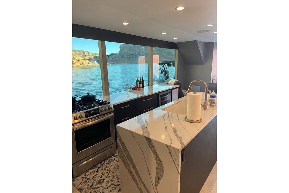 Modern kitchen on Adonia's 2021 "The Queen Elizabeth" yacht with scenic water view.