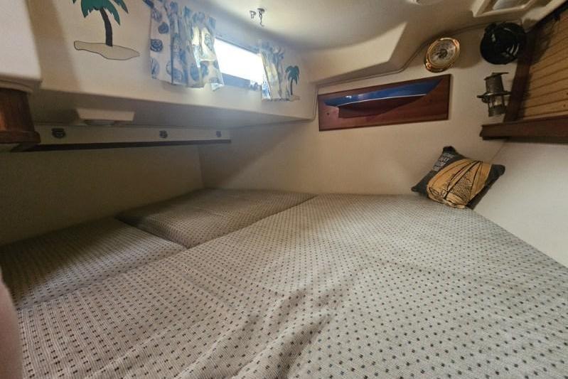 Cozy cabin interior of a 1999 Island Packet 350 sailboat with nautical decor.