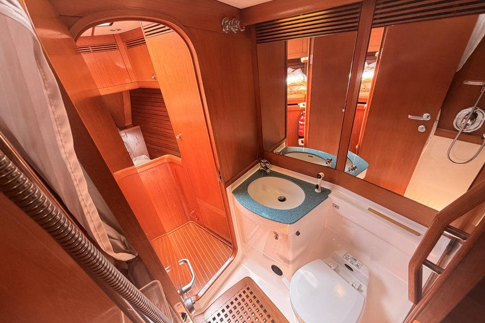 Luxurious 1996 Nautor Swan 60 yacht bathroom with wooden accents and modern fixtures.
