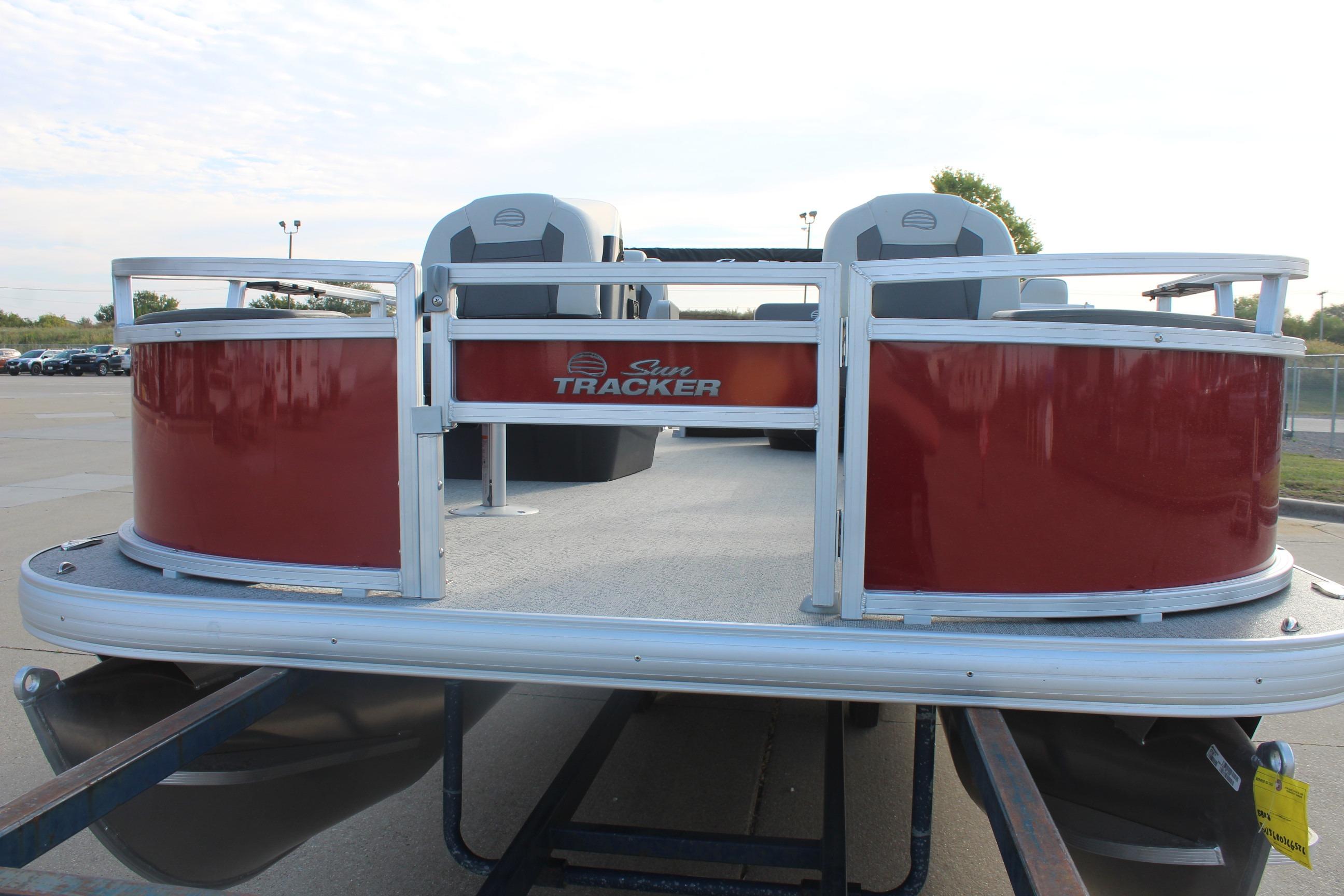 2026 Sun Tracker Bass Buggy 18 DLX pontoon boat with red exterior on trailer.