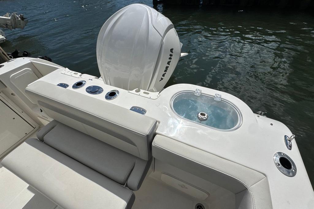 2025 Sailfish 245 DC boat with Yamaha engine, featuring a sleek seating area and livewell.