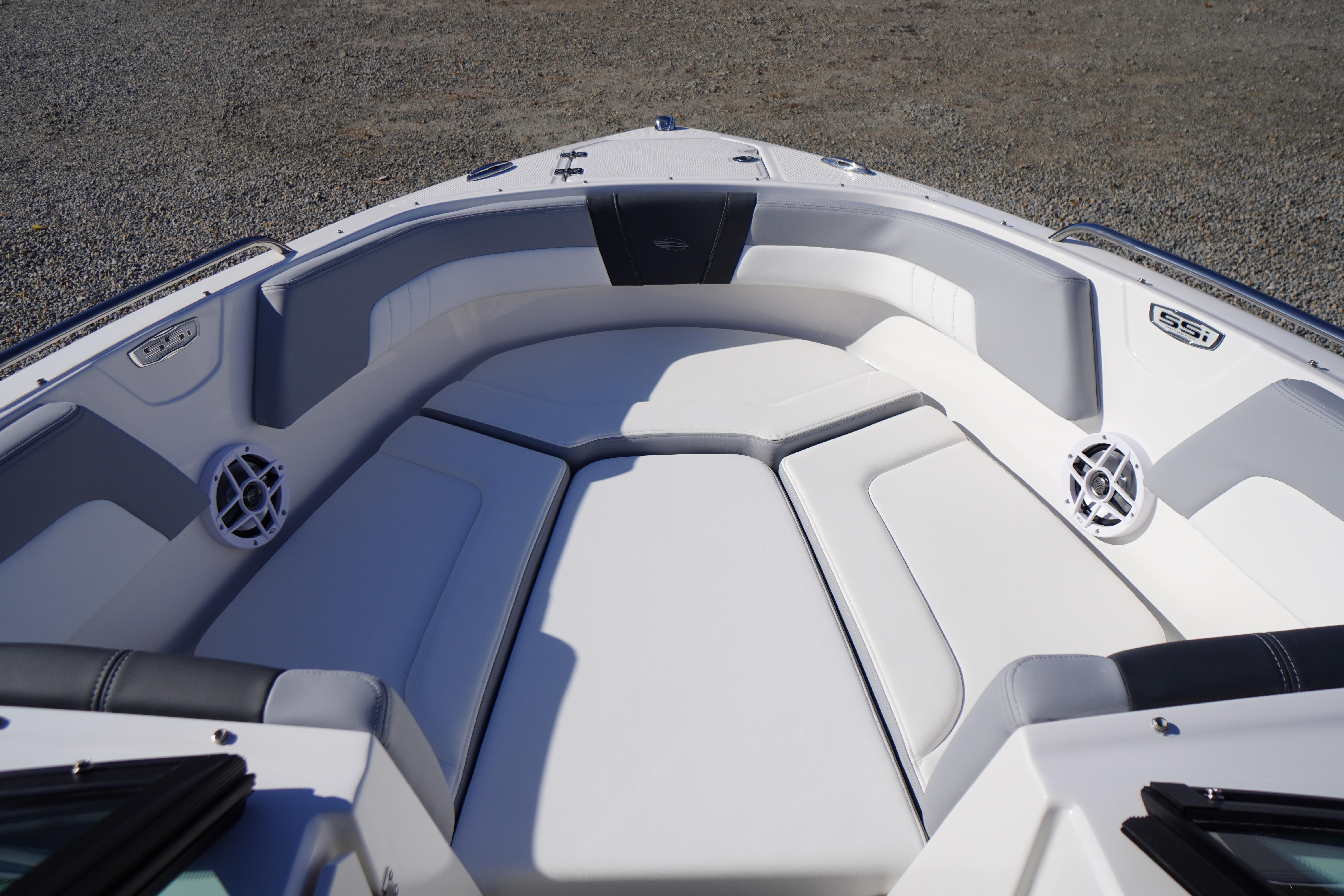 2026 Chaparral 23 SSi OB boat interior with white cushioned seating and speakers.
