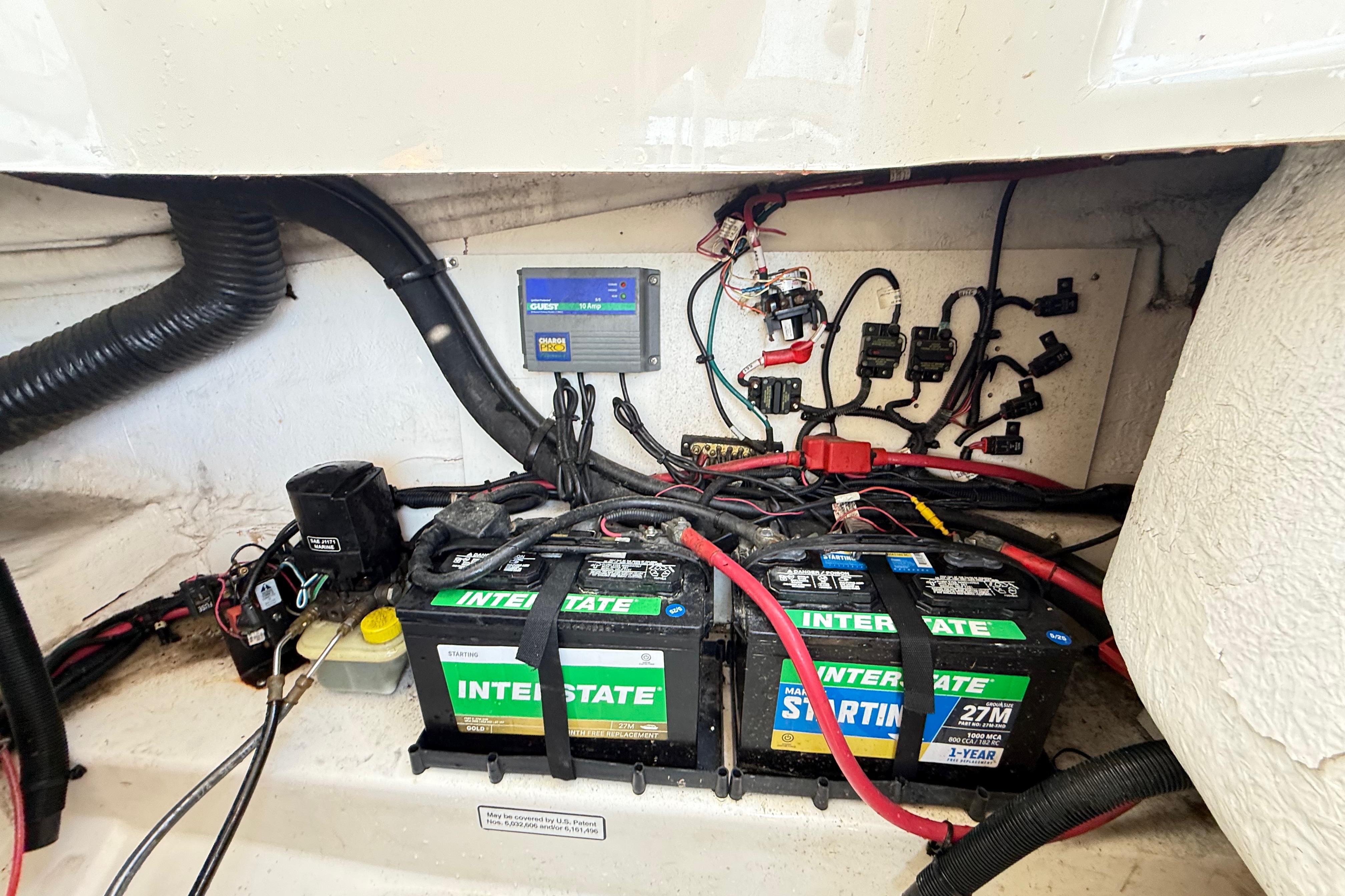 Battery compartment of a 2011 Sea Ray 270 SLX with Interstate batteries and wiring.