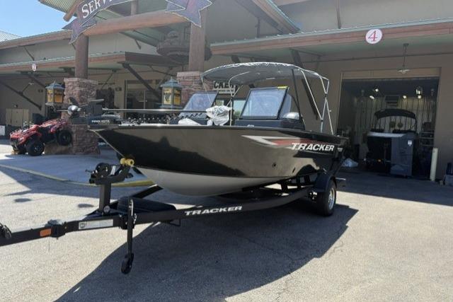 2026 Tracker Pro Guide V-175 WT boat on trailer outside a service center.