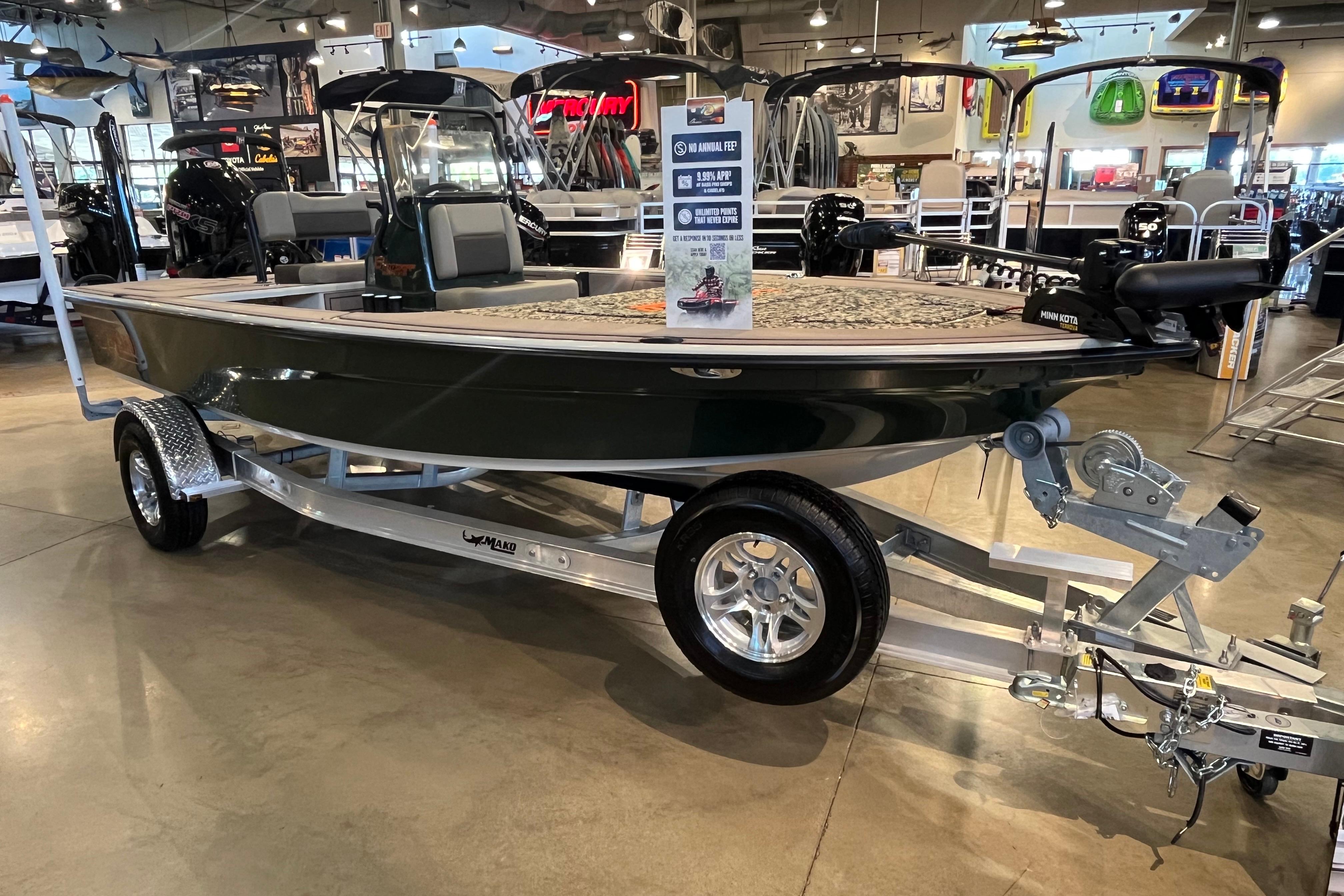 2025 Mako 18 Pro Skiff Backwater Edition displayed in showroom on trailer.