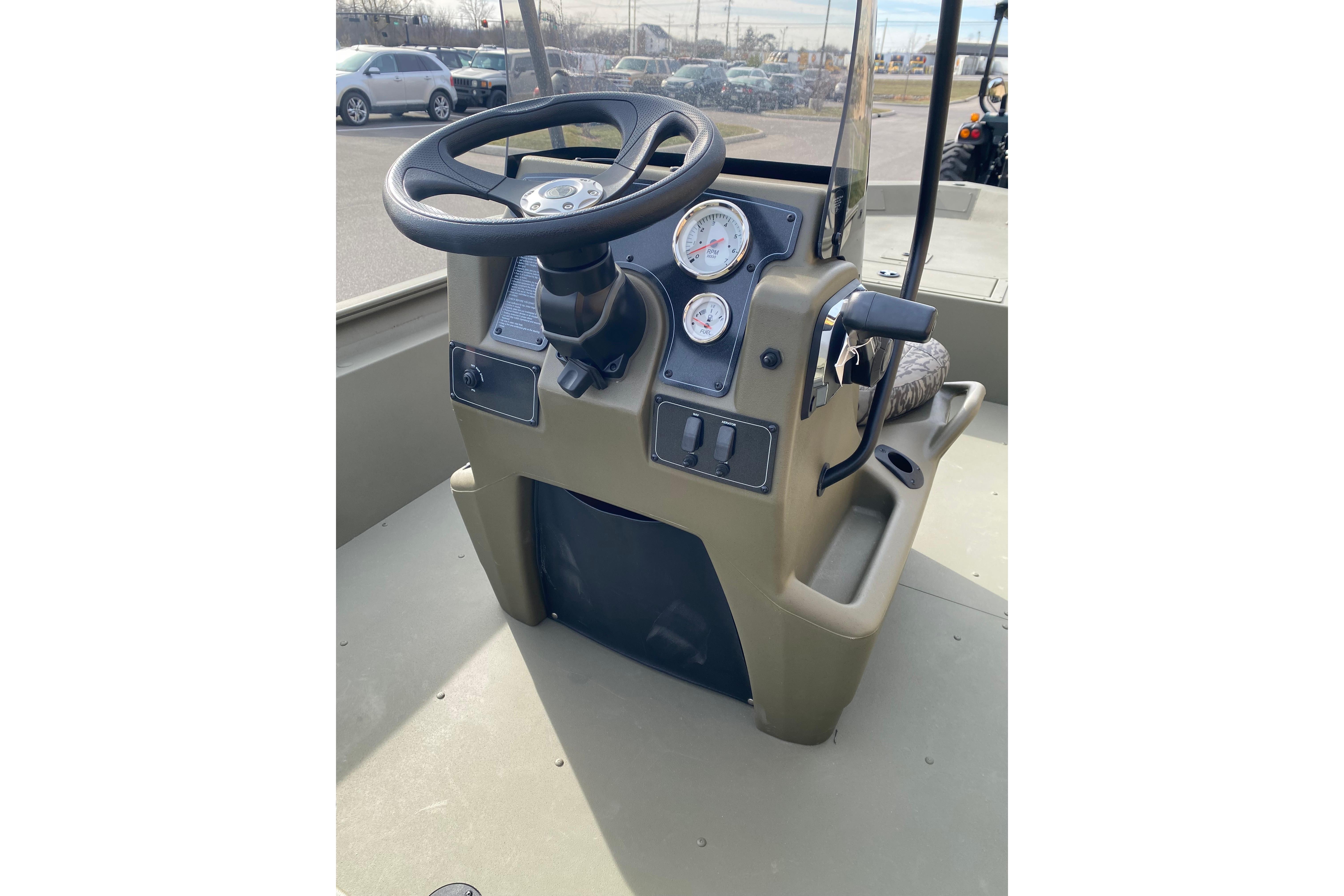 Steering console of 2026 Tracker Grizzly 1860 CC boat with gauges and controls.
