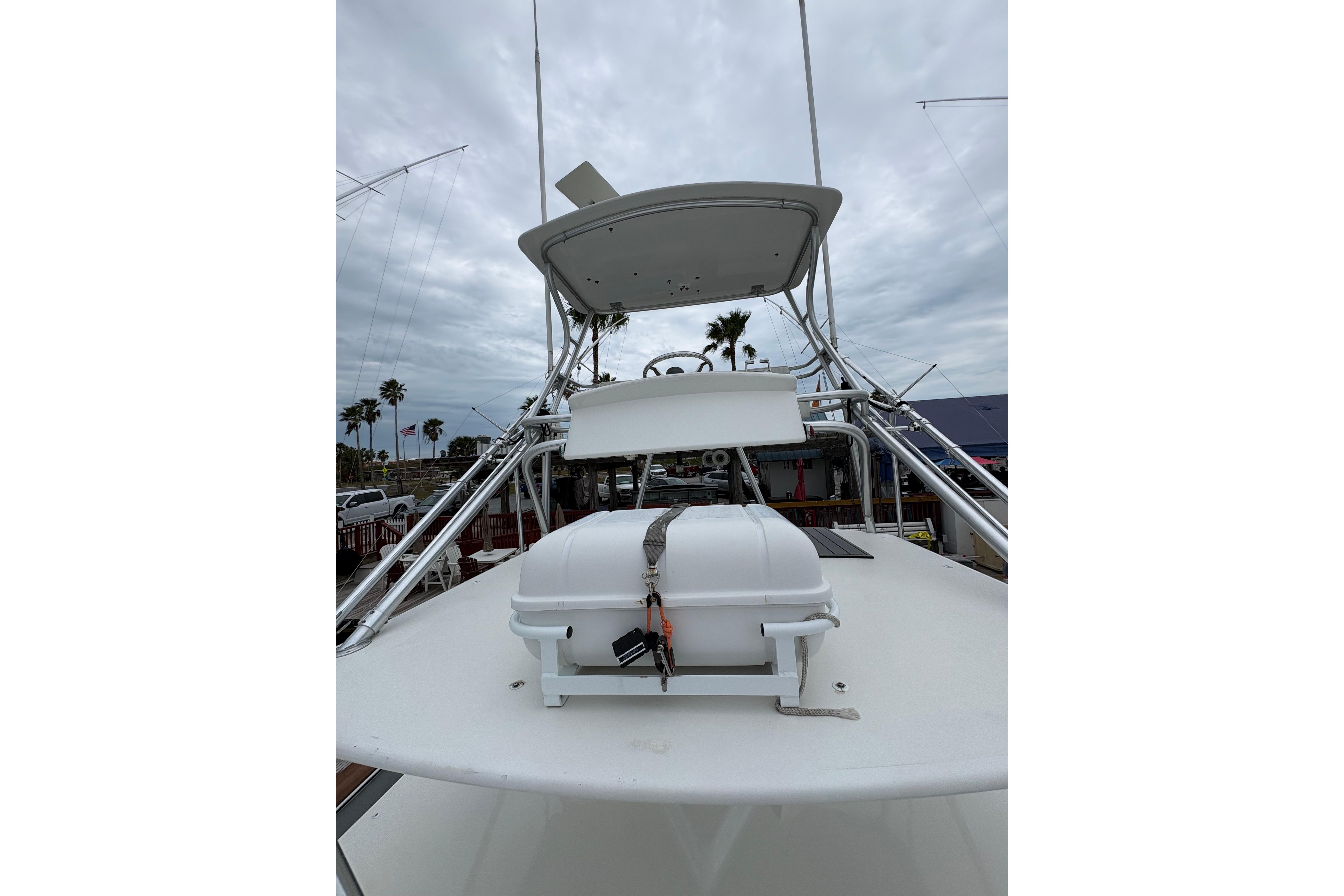 2004 Cabo 40 Hardtop Express boat with tower and equipment on deck.