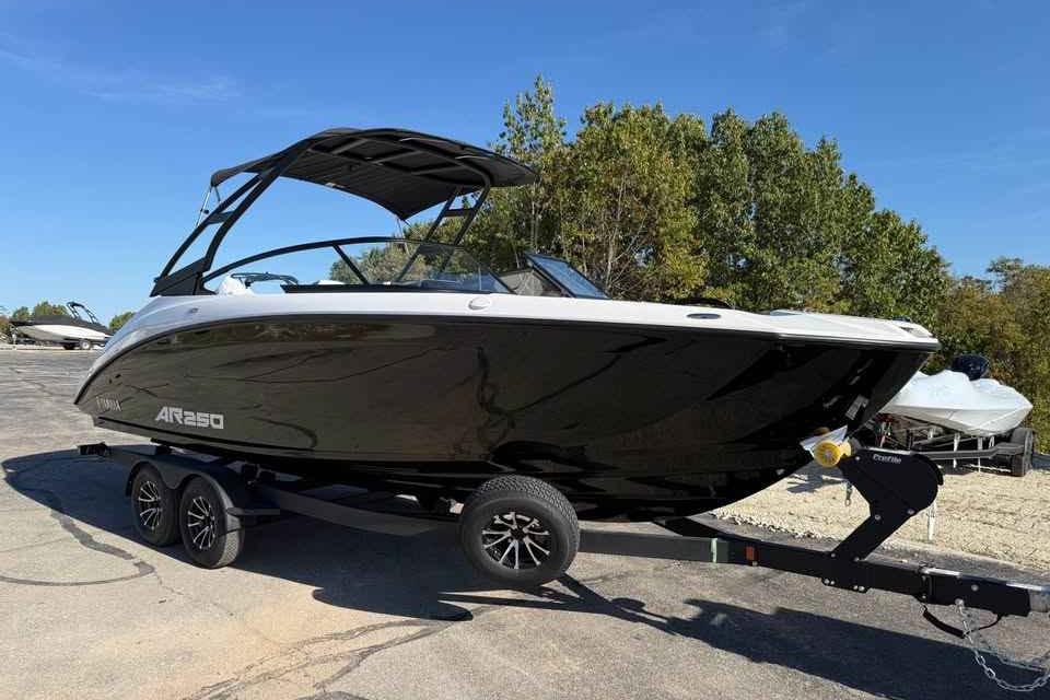 2026 Yamaha Boats AR250 on trailer, sleek black design, parked outdoors.