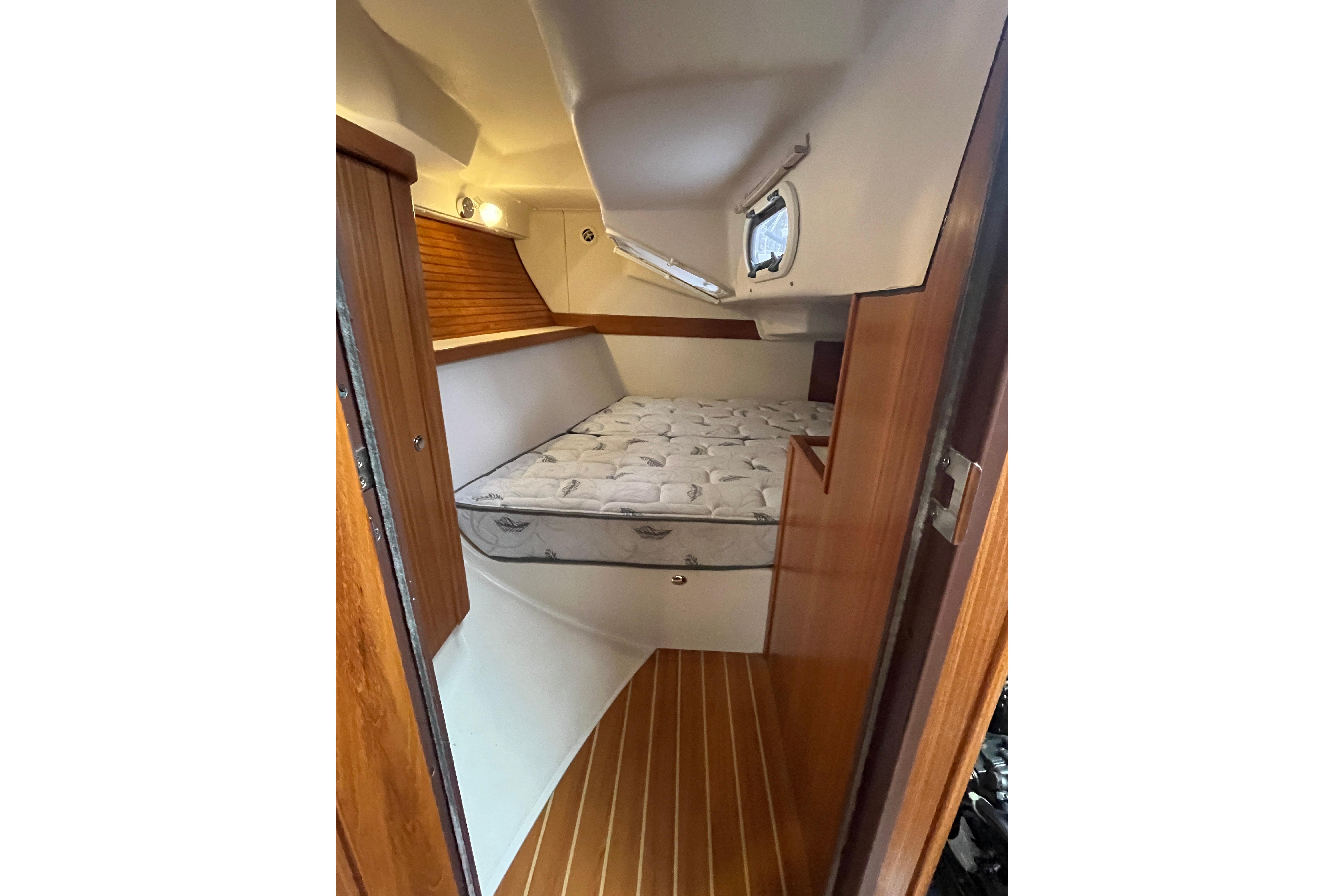 2017 Catalina 355 yacht interior cabin with bed and wooden flooring.