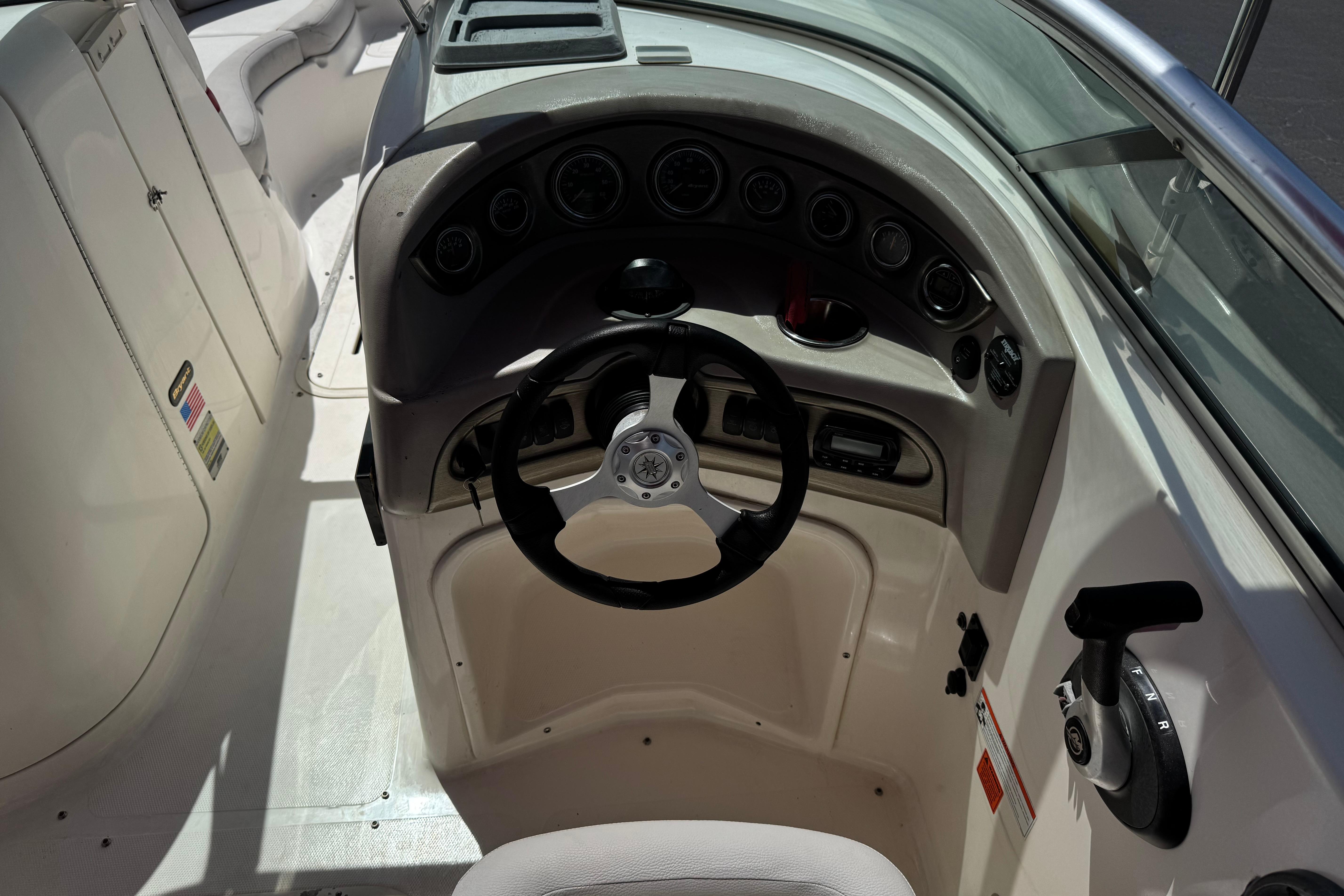 Steering console of a 2010 Bryant 255 boat with gauges and controls.