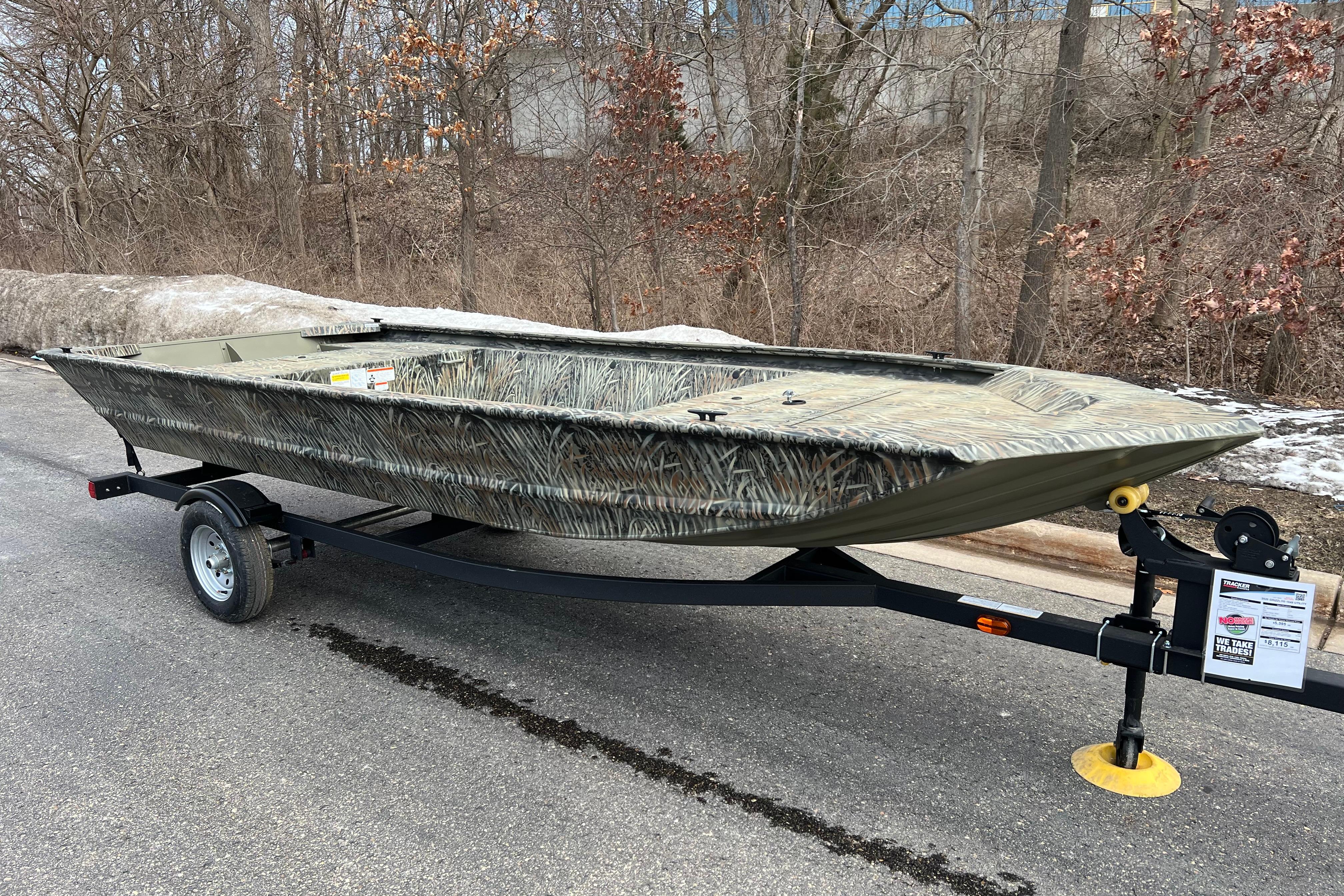 2026 Tracker Grizzly 1648 Utility boat on trailer, parked on a road.