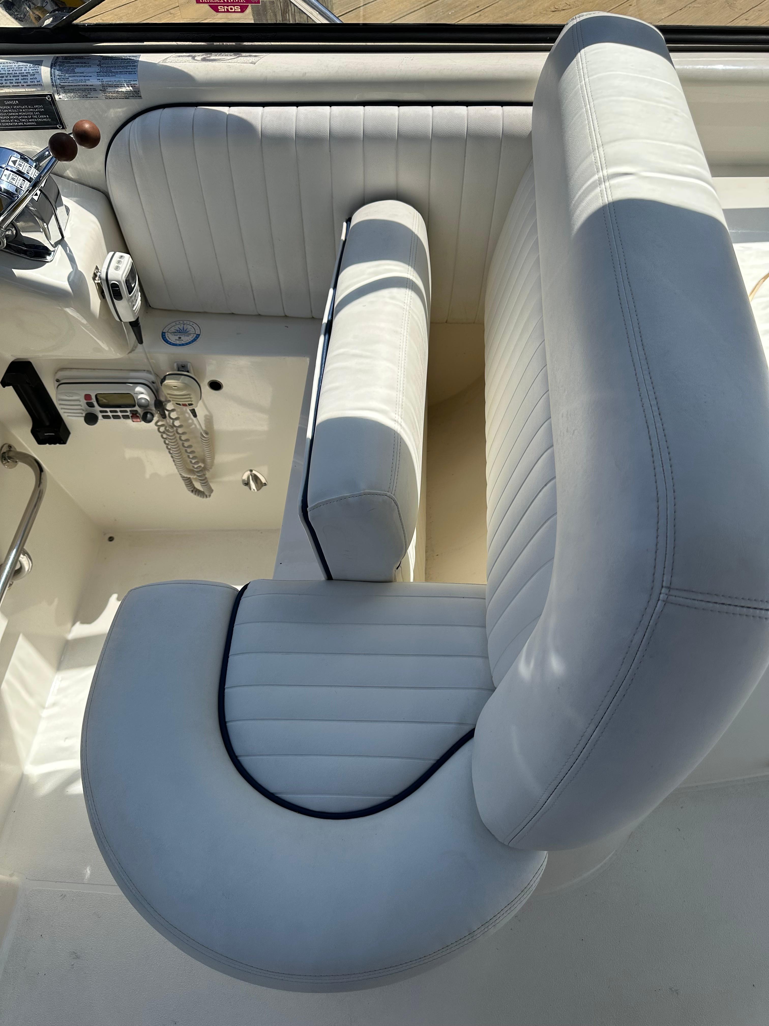 Luxurious white seating on 1997 Sunseeker Camargue 47 yacht, showcasing elegant design.
