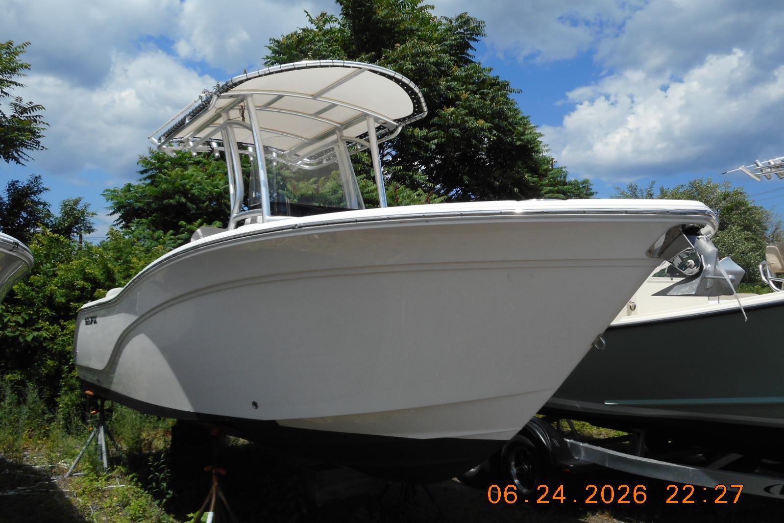 2022 Sea Fox 228 Commander boat on display under a clear blue sky.