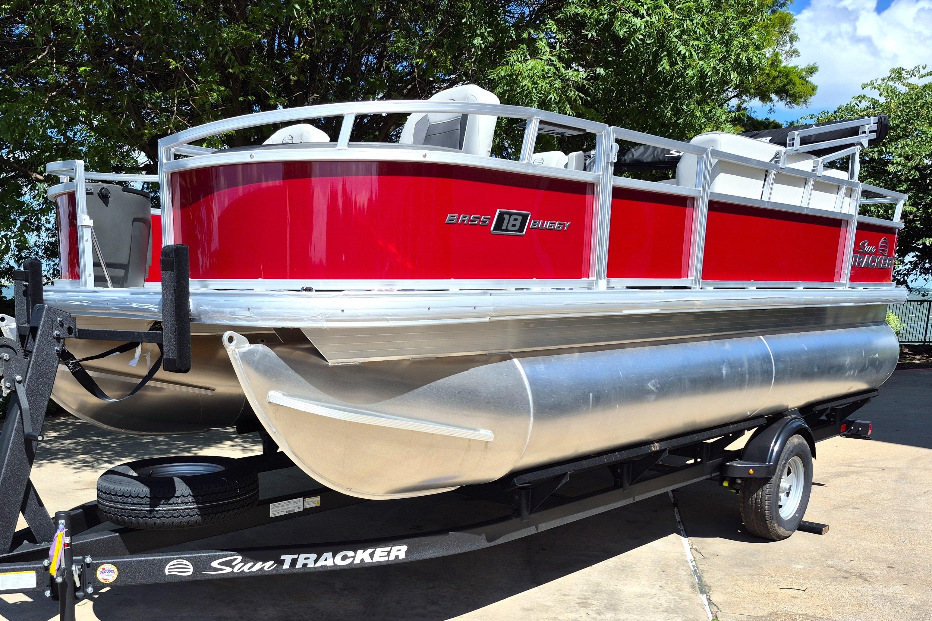 2026 Sun Tracker Bass Buggy 18 DLX pontoon boat on trailer, vibrant red exterior.