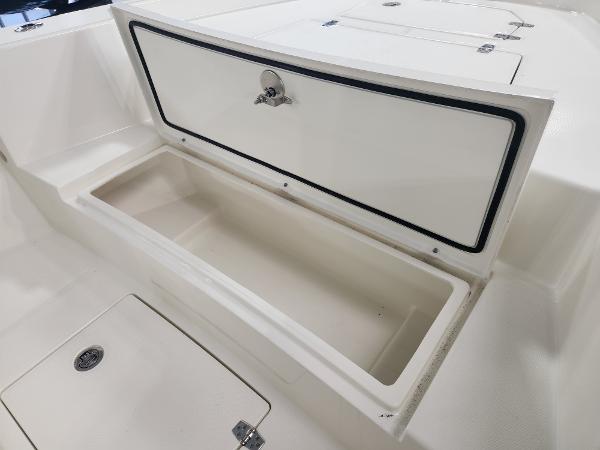 2025 Pathfinder 2400 Open boat storage compartment, open lid, white interior.