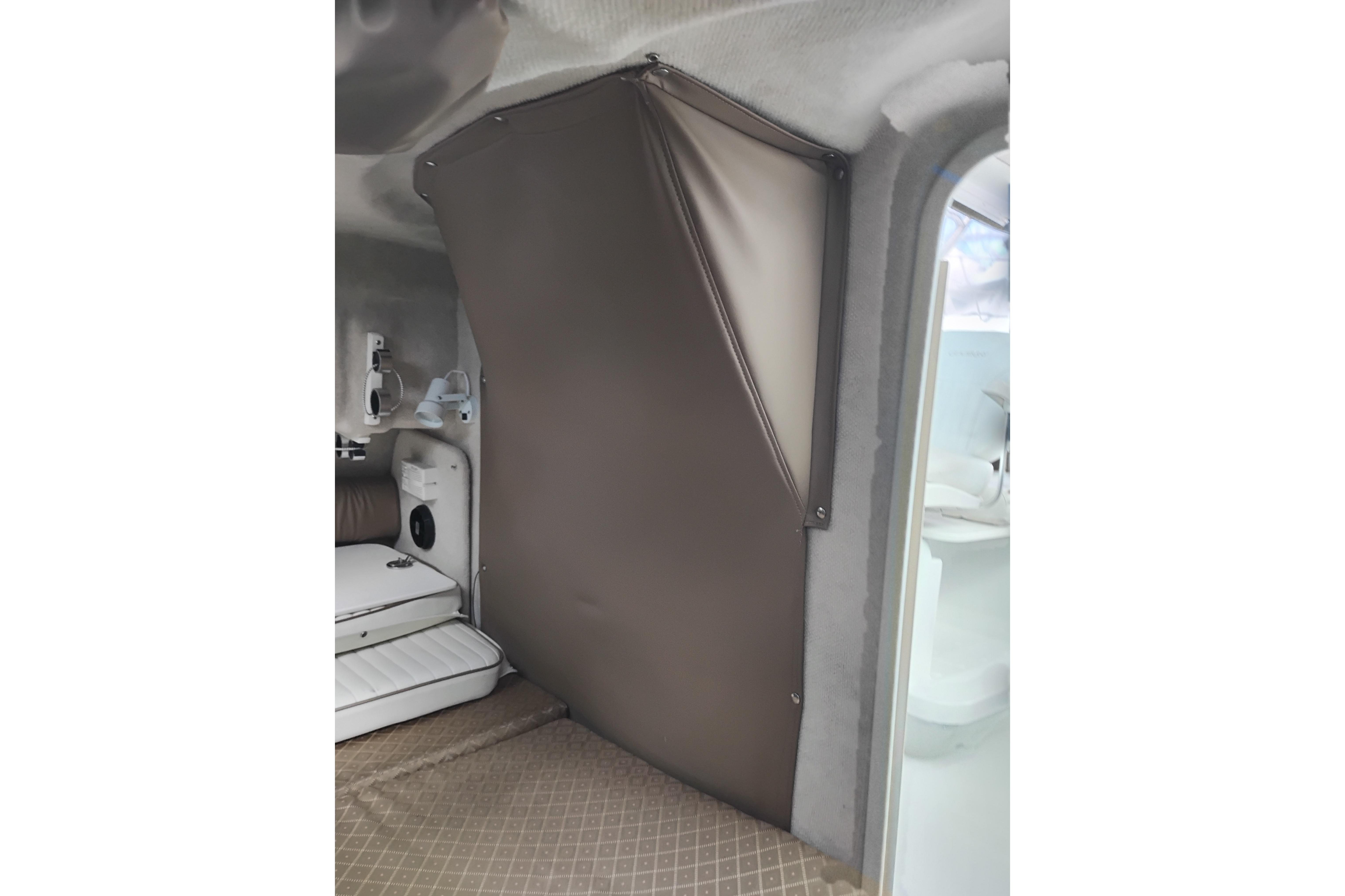 Interior of 2007 Glacier Bay 2685 Coastal Runner boat, featuring cabin seating and storage.