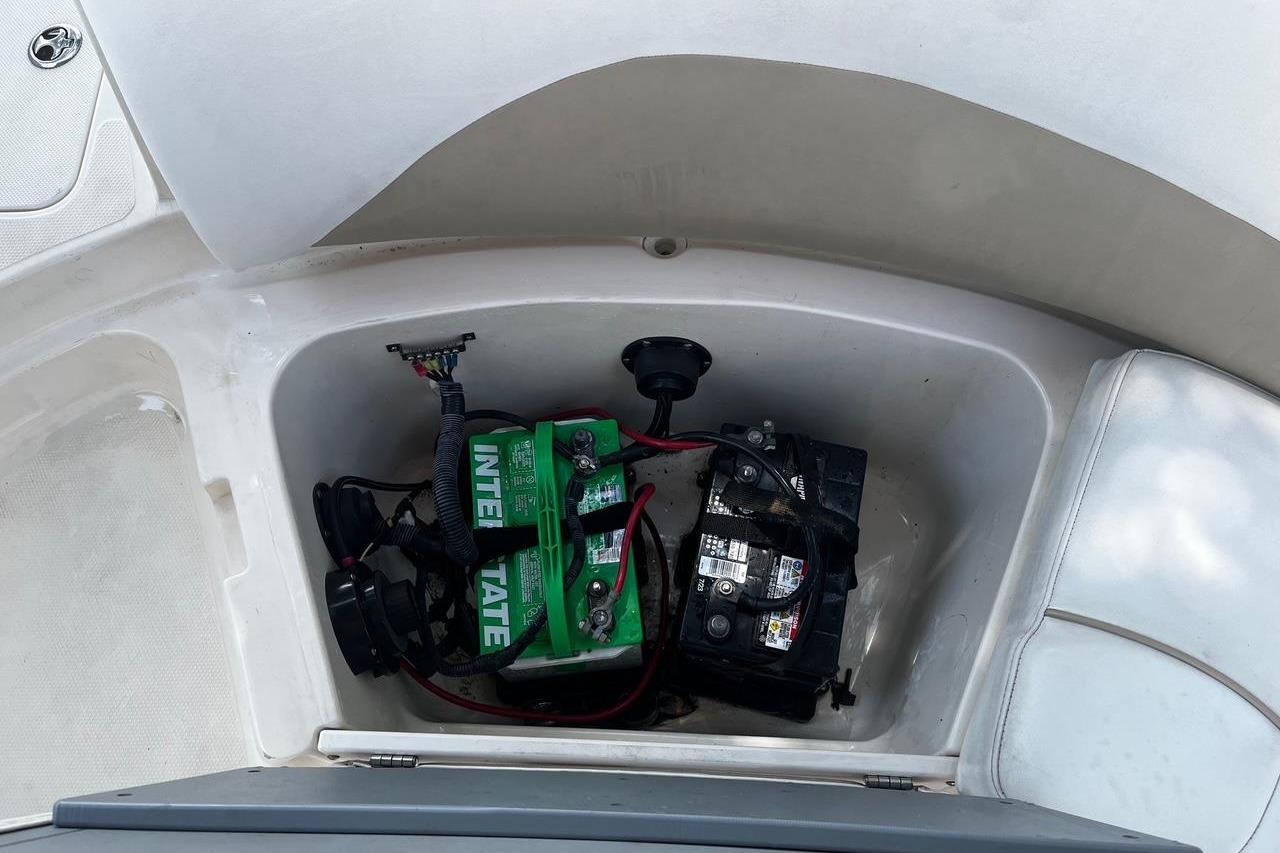 Battery compartment of a 2008 Hurricane FD202 boat, featuring Interstate batteries.