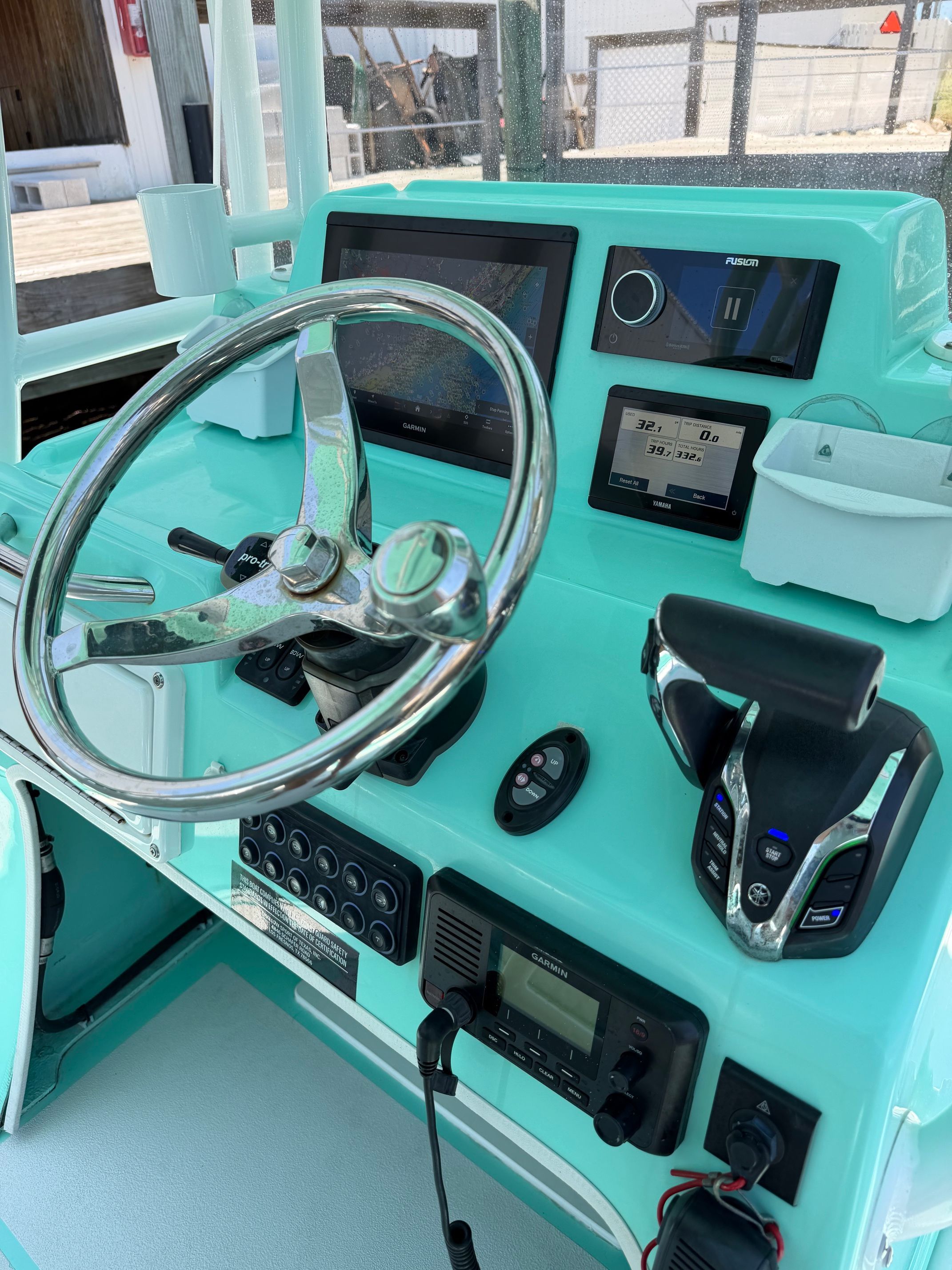 The cockpit of a Shallow Sport 25 X3 boat with modern instruments and controls.