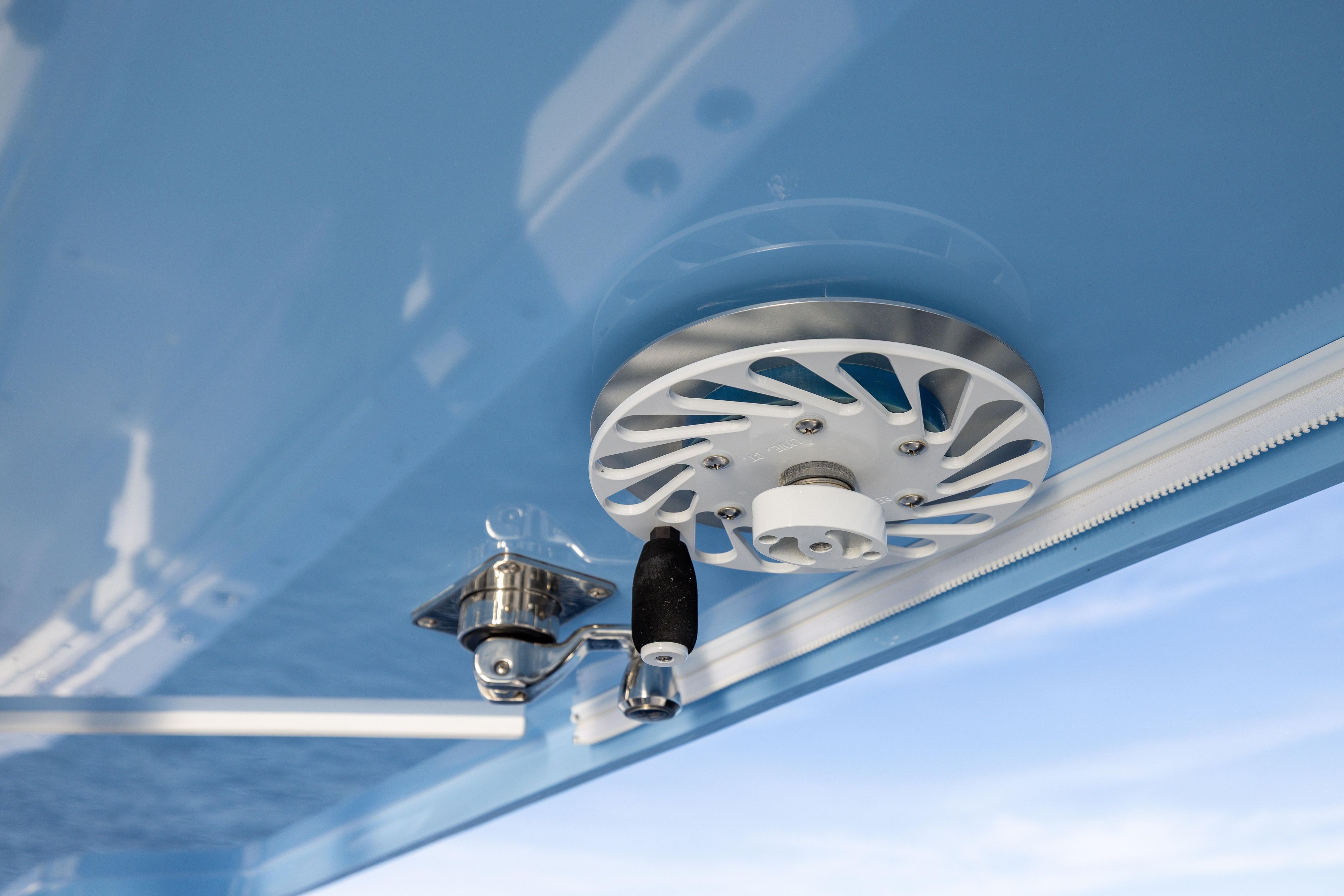 Close-up of 2024 Invincible 40 Catamaran's ceiling mechanism against blue sky.