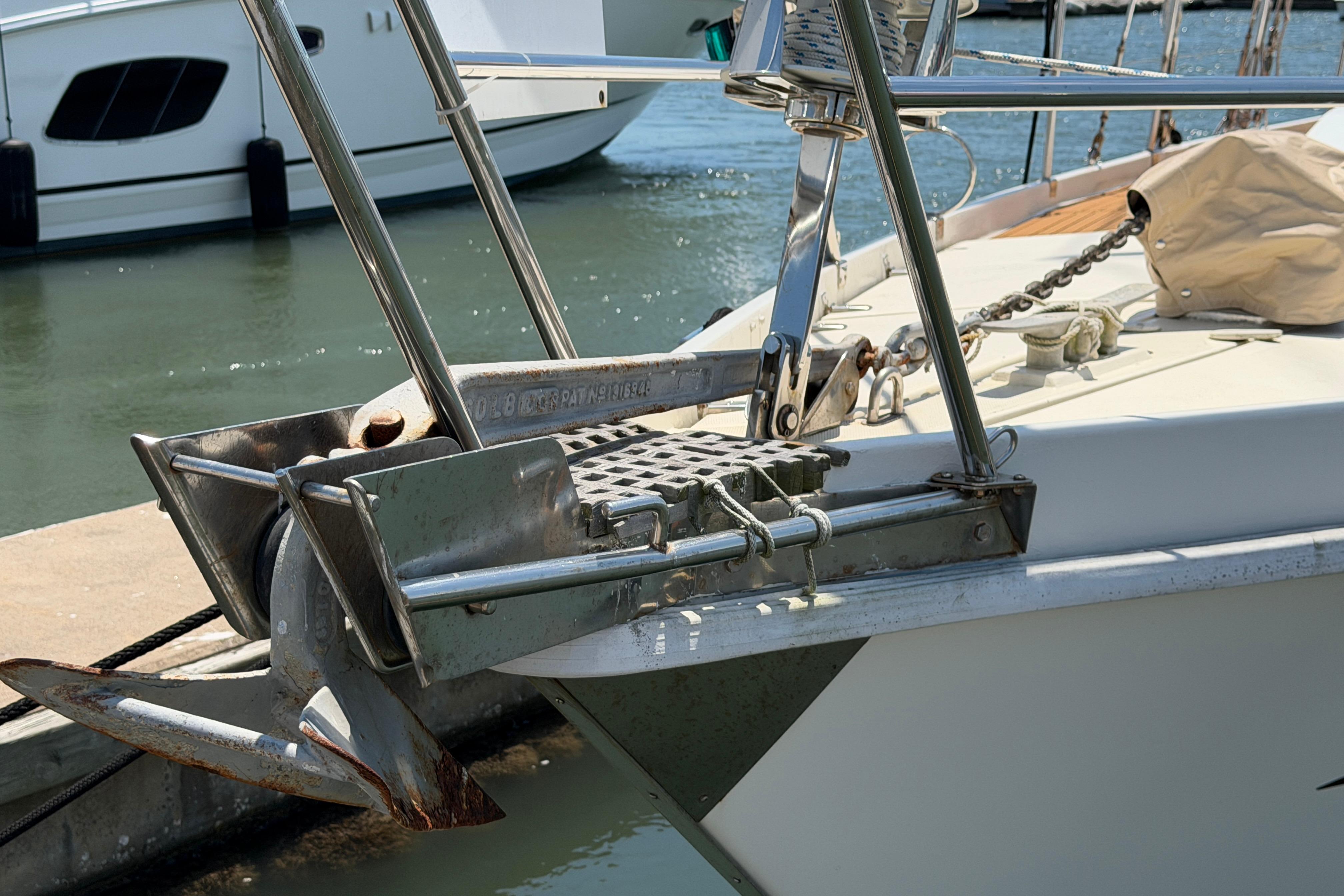 Bow of 1980 Amel Mango 52 yacht with anchor and chain at dock.