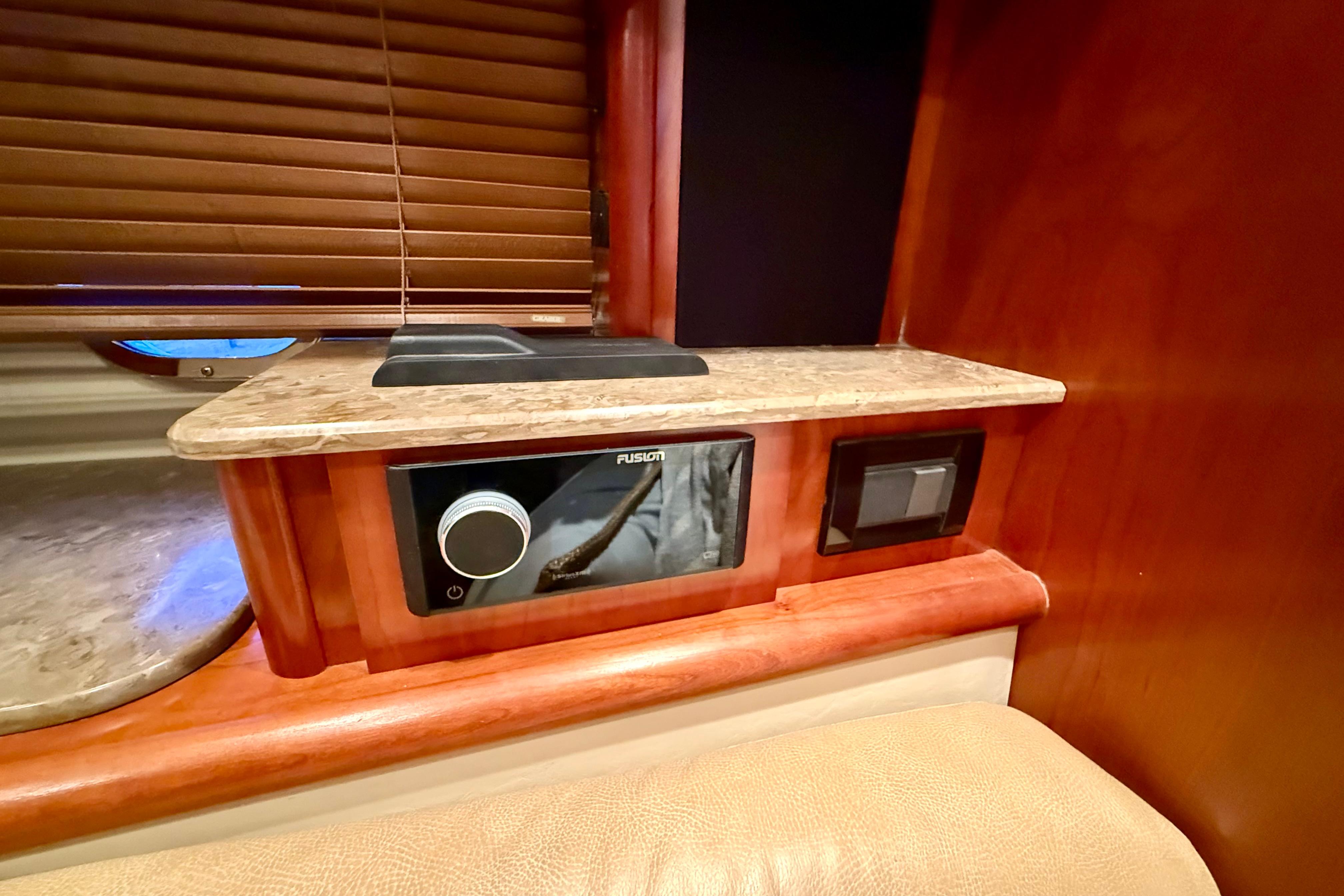 Interior of 2011 Cruisers Yachts 390 Sports Coupe with Fusion audio system and wooden accents.