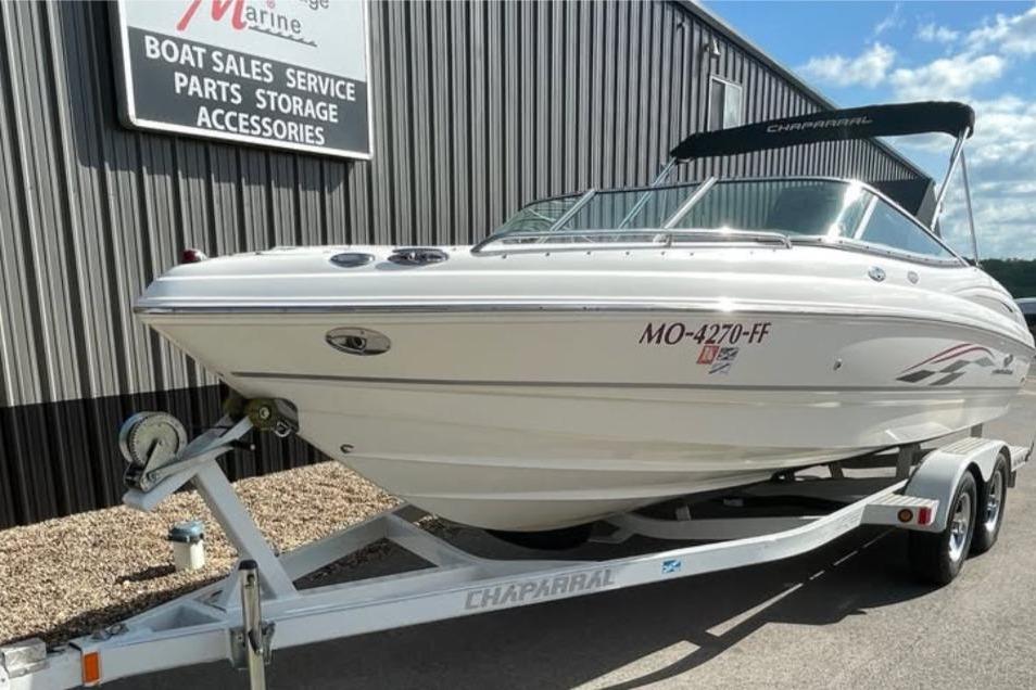 2005 Chaparral 210 SSi boat on trailer at marine service center.