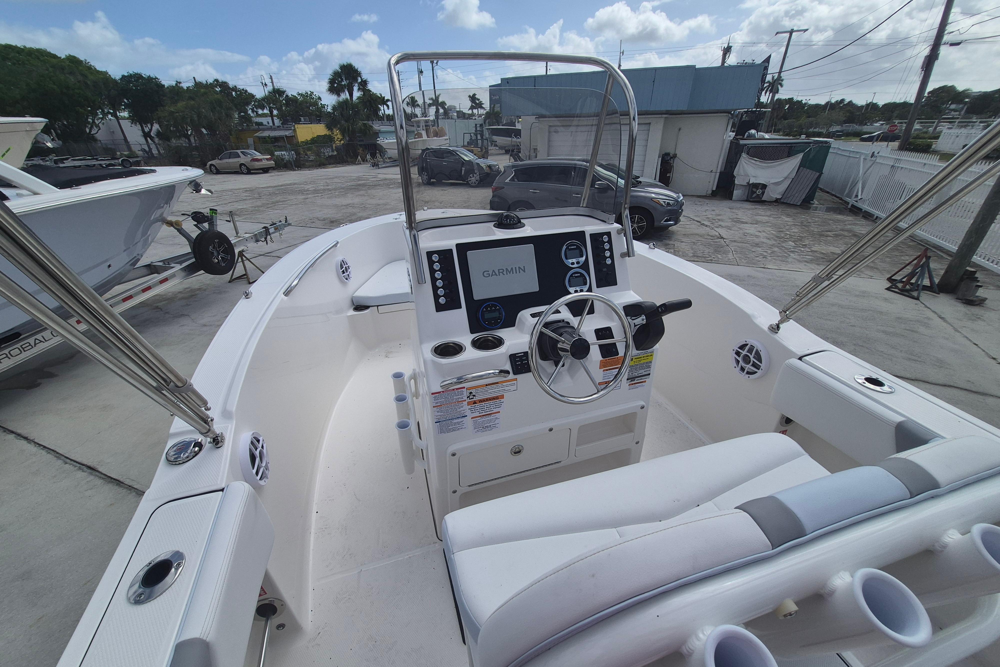 2026 Robalo R180 Center Console boat with Garmin navigation, docked outdoors.