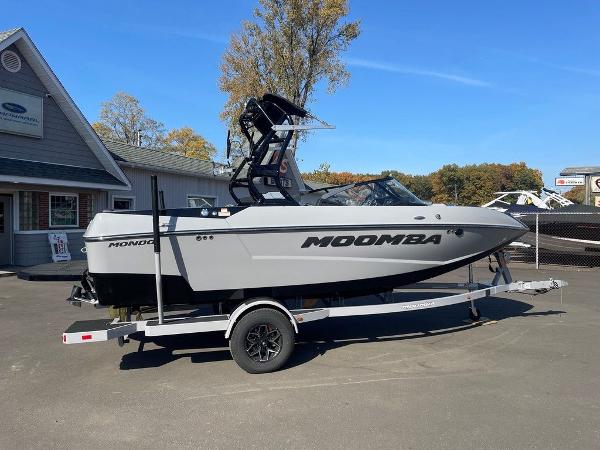 2025 Moomba Mondo boat on trailer, parked outside dealership on a sunny day.