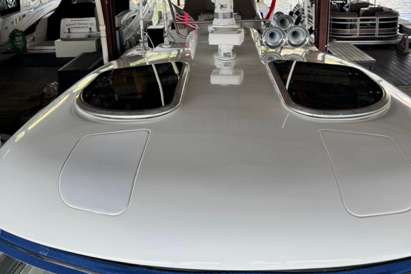 2008 Formula 400 Super Sport yacht with sleek deck and dual hatches in marina.