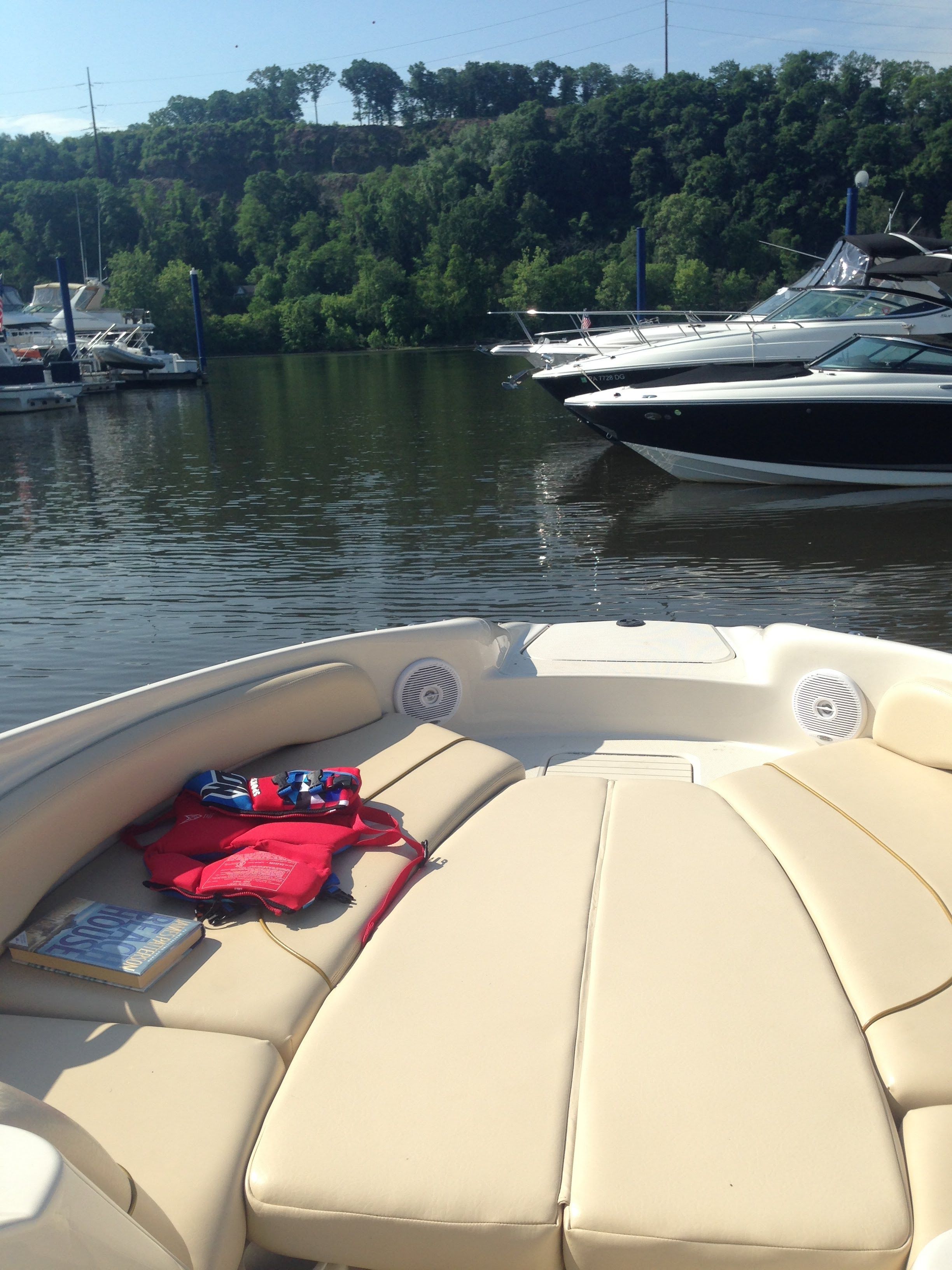 Sea Ray 240 Sundeck 2001 on calm water with boats in background.