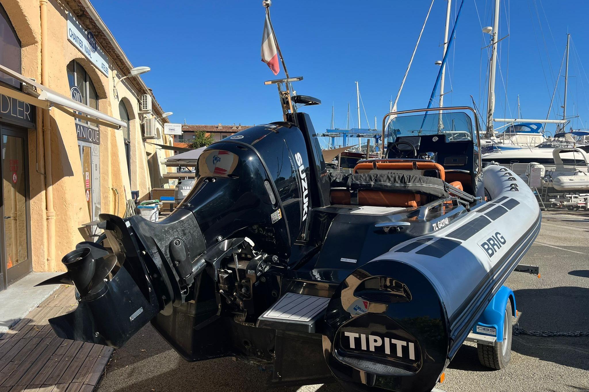 2022 Brig Eagle 6.7 boat with Suzuki engine, docked at marina under clear blue sky.