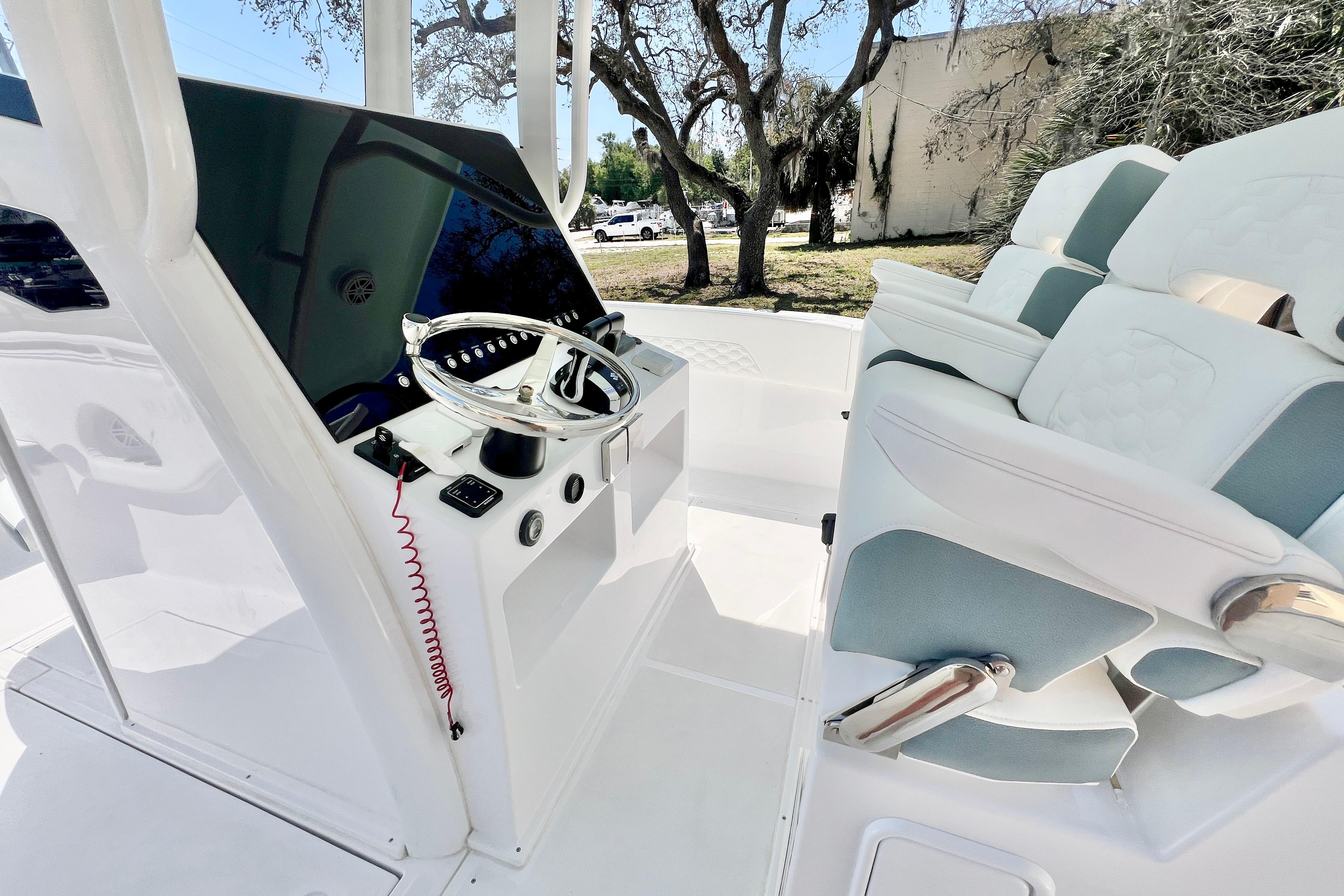 2026 Stamas 31T Aventura boat cockpit with modern steering and cushioned seating.