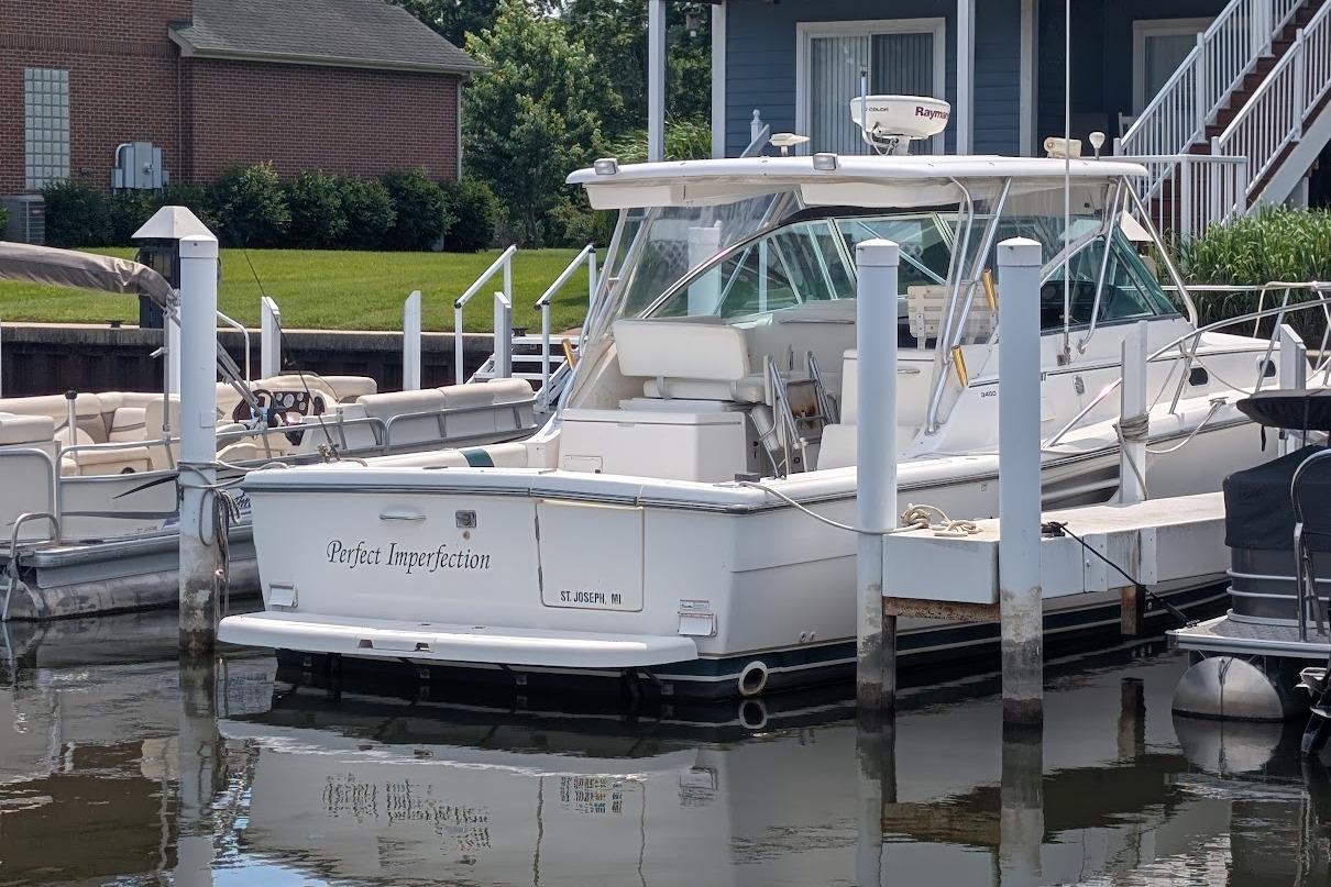 2000 Pursuit 3400 Express boat docked at marina, named "Perfect Imperfection."