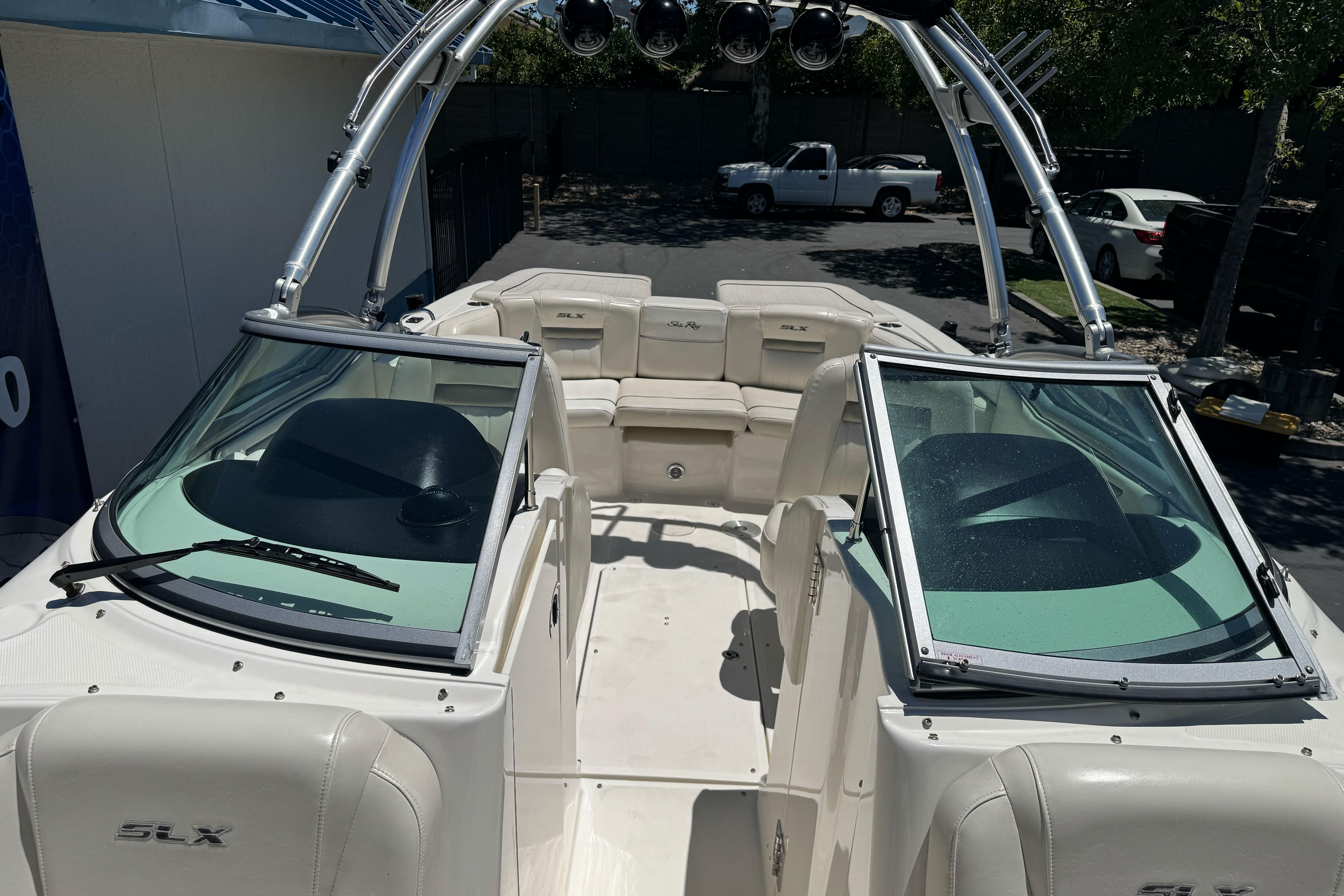 2007 Sea Ray SLX 250 boat interior with seating and windshield, parked outdoors.