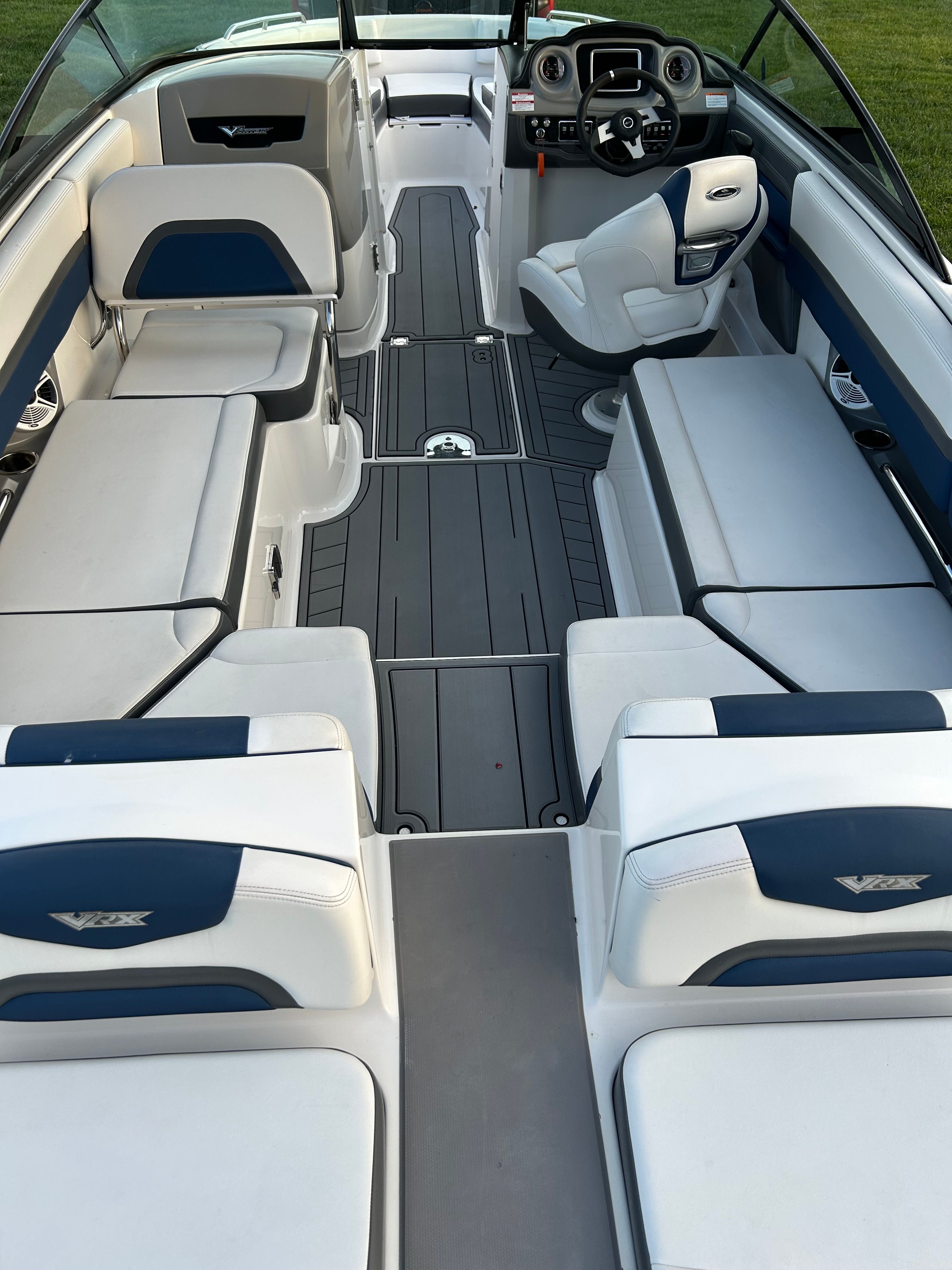Interior of 2015 Chaparral Vortex 243 VRX with gray and blue seating.