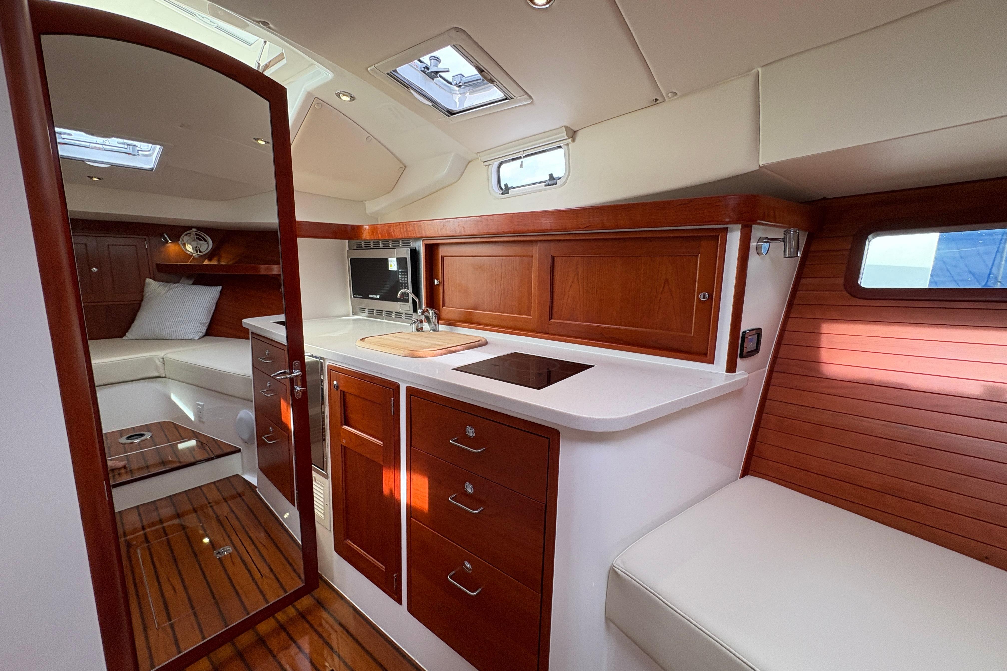 Luxurious interior of 2023 MJM 35 yacht with modern kitchen and seating area.