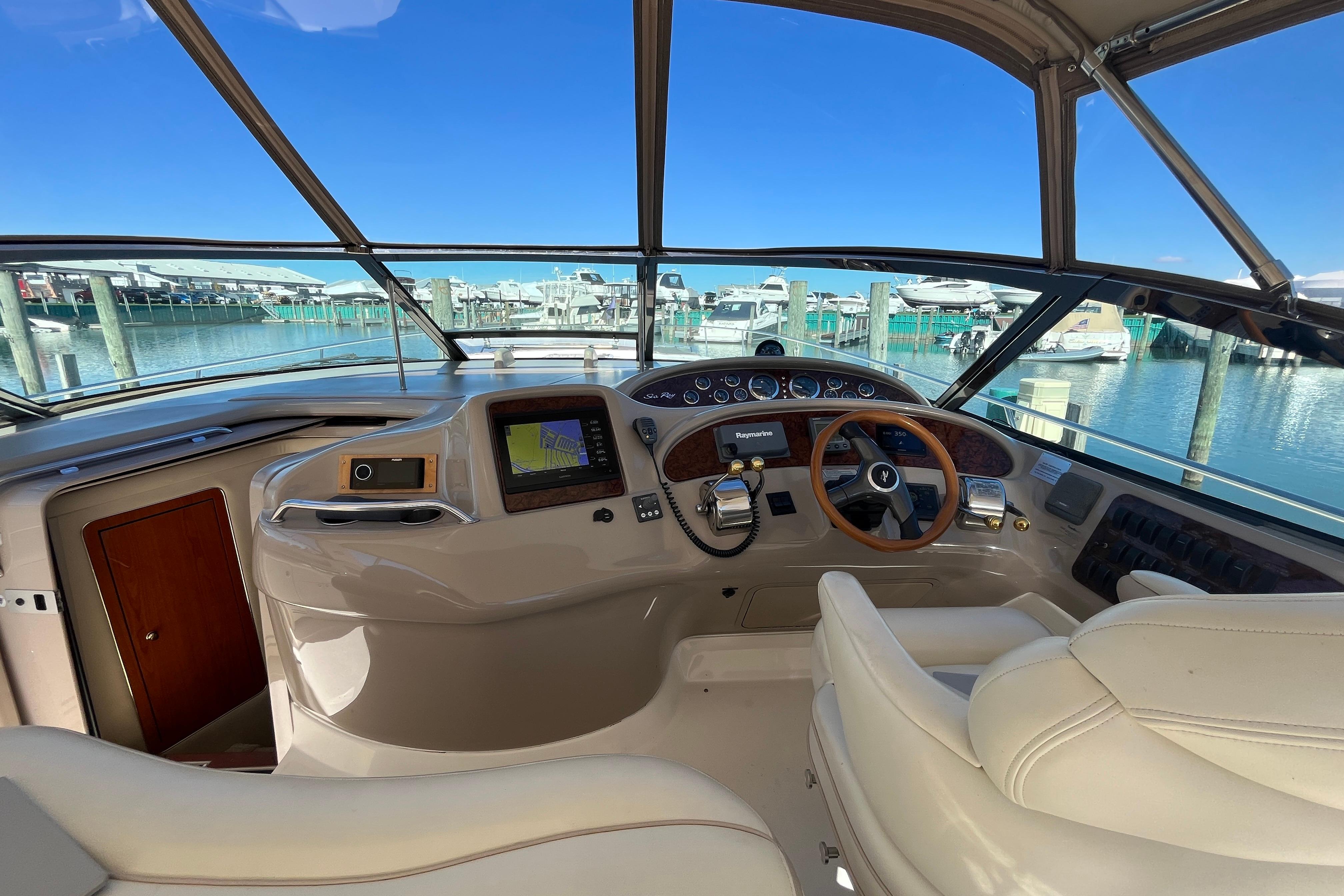 Cockpit of 2000 Sea Ray 460 Sundancer yacht with marina view.