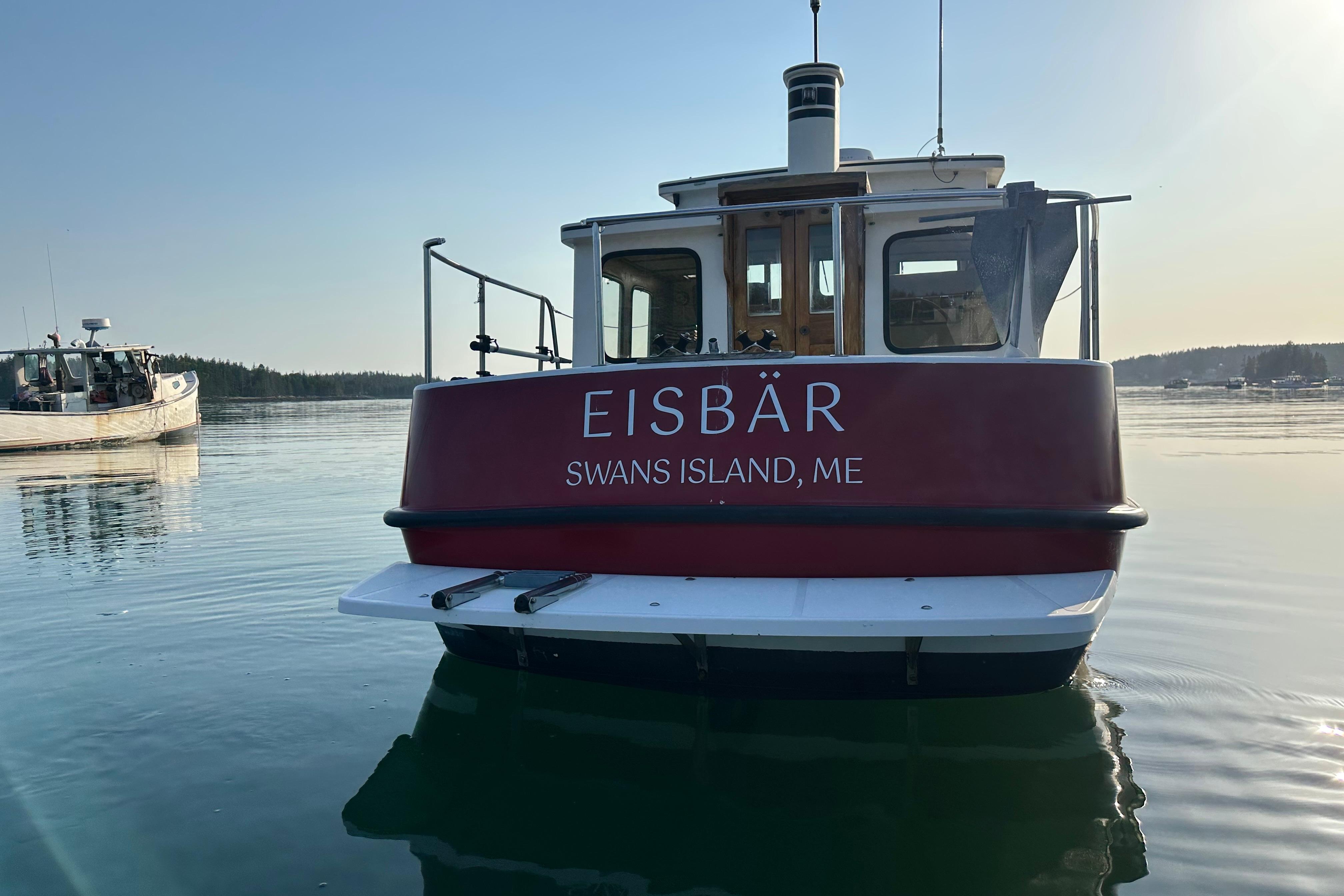 1985 Nordic Tug 26 named "Eisbär" on calm water near Swans Island, ME.