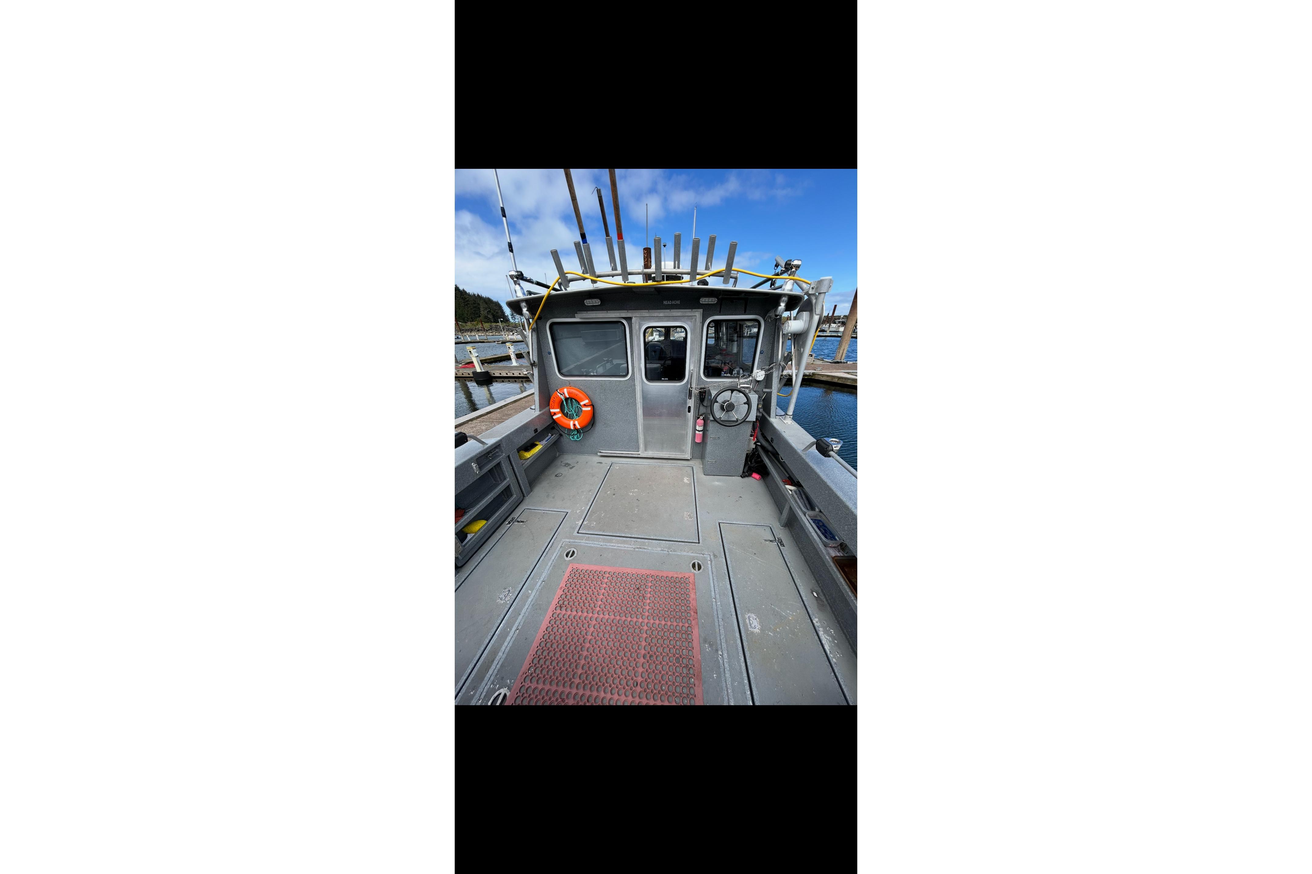 2016 North River 29 OFFSHORE boat interior with fishing rods and life preserver.