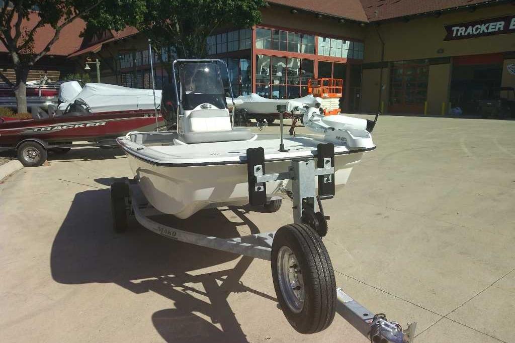2026 Mako Pro Skiff 13 CC boat on trailer in outdoor showroom.