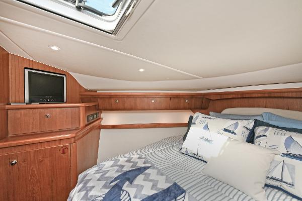 2008 Tiara Yachts 4200 Open cabin with cozy bedding and wooden interior.
