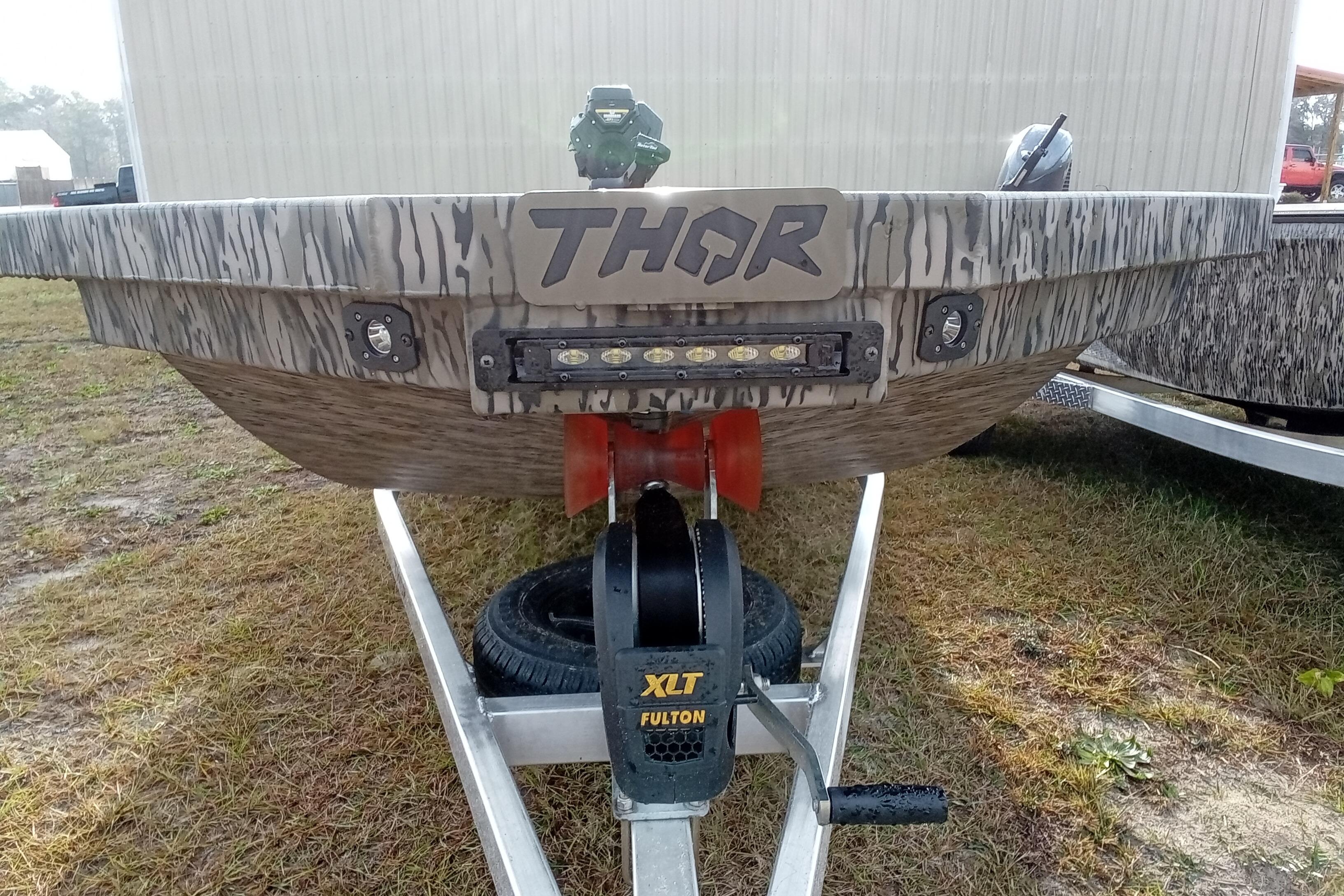 2026 Thor 1754 Swamp Hammer boat on trailer, featuring camo design and LED lights.