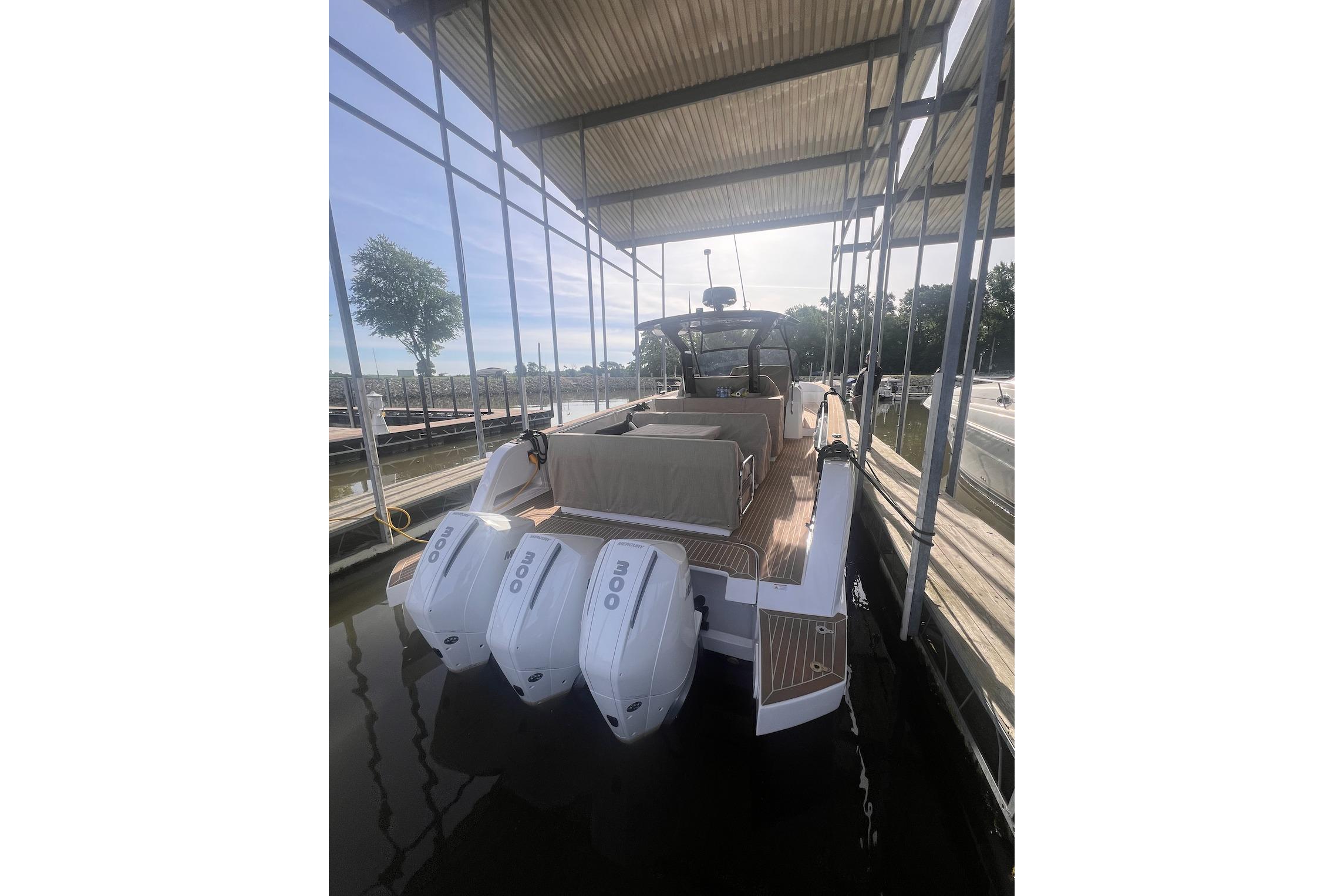 2024 Pardo Yachts P38R docked, showcasing triple outboard engines and sleek design.