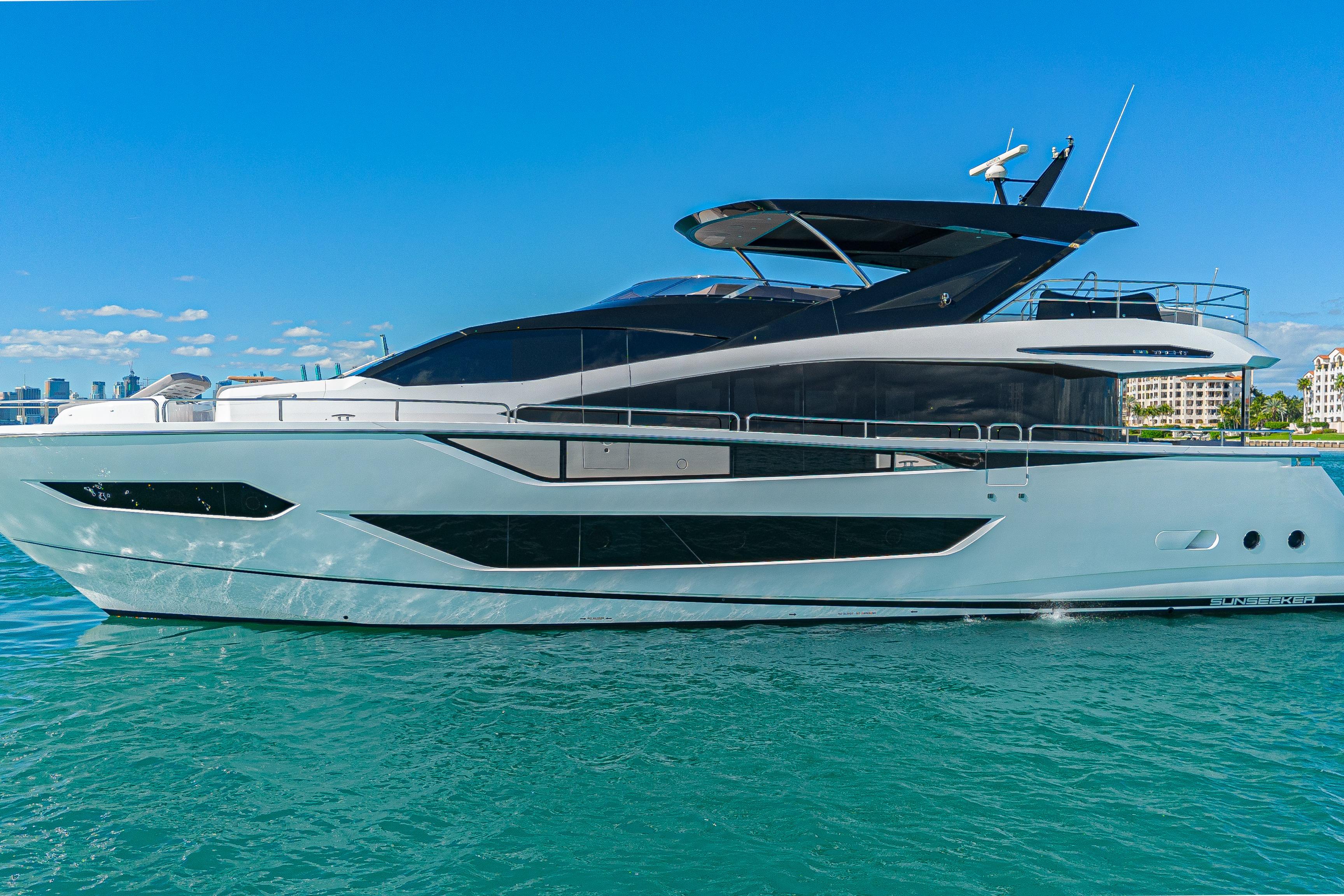 2025 Sunseeker 88 Yacht on clear blue water, showcasing sleek design and luxury features.