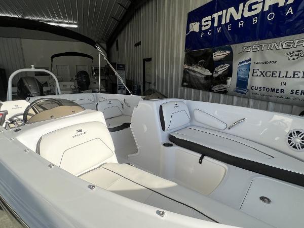 2025 Stingray 172SC boat interior in showroom, featuring white seating and modern design.