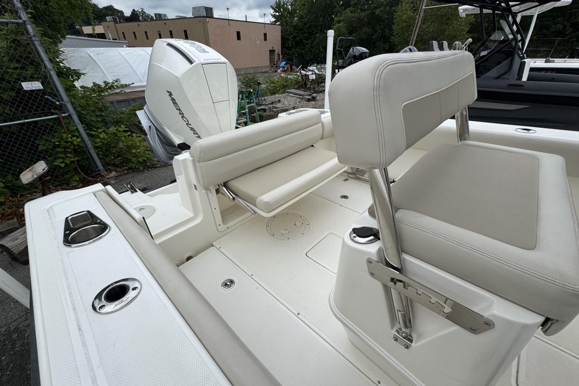 2024 Boston Whaler 230 Outrage boat interior with seating and Mercury engine.